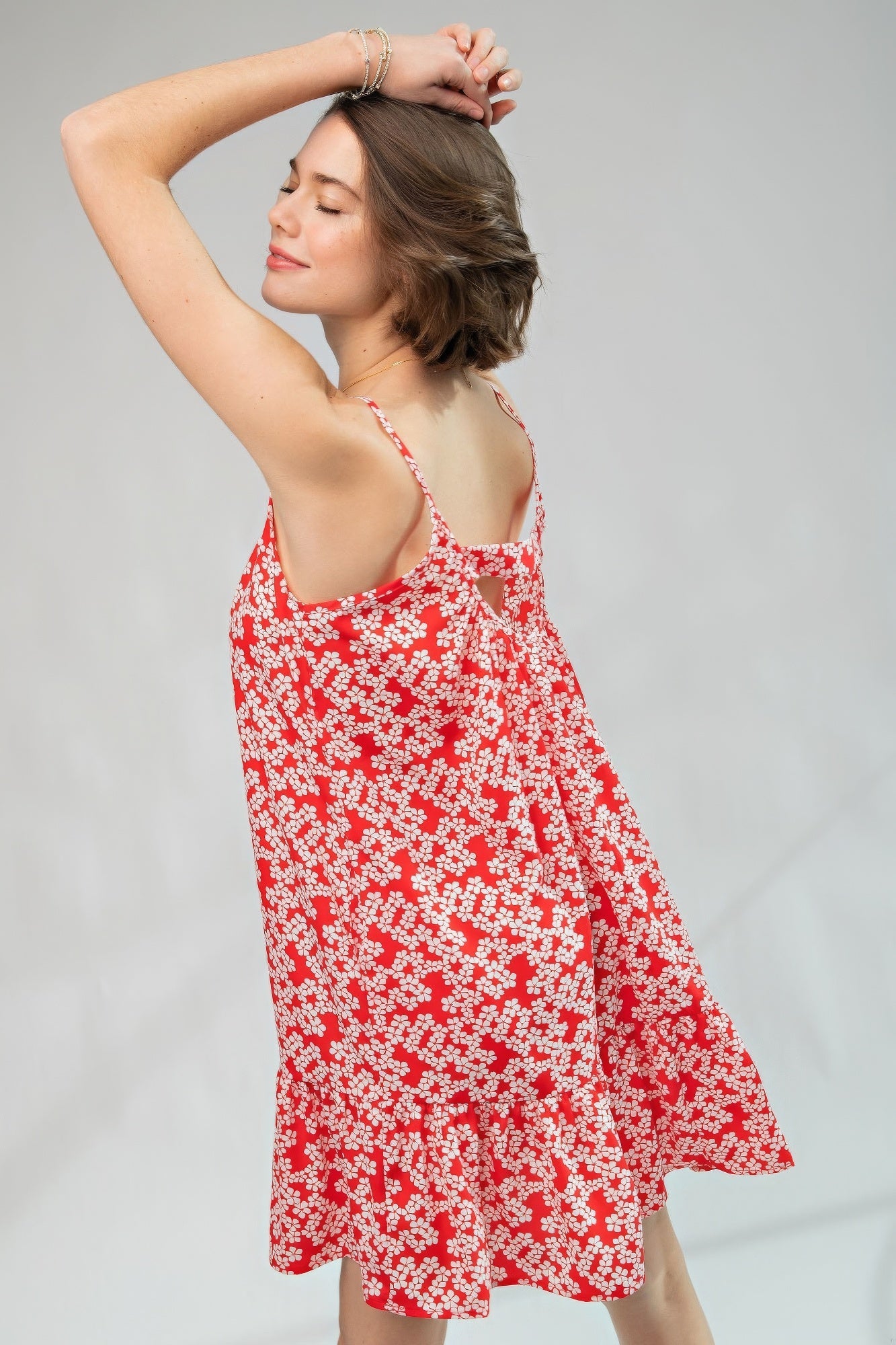 The Cassia is our floral printed wool peach cami dress, an enchanting piece that seamlessly blends floral elegance with the comfort of a loose and relaxed fit. This dress features a scoop neckline, ruffled bottom, and spaghetti straps for a touch of feminine charm. Made of 100% Polyester which provides a lightweight and breathable feel. Perfect for sunny days, casual outings, or any event where you want to exude a laid-back yet stylish vibe with a pop of confident red.