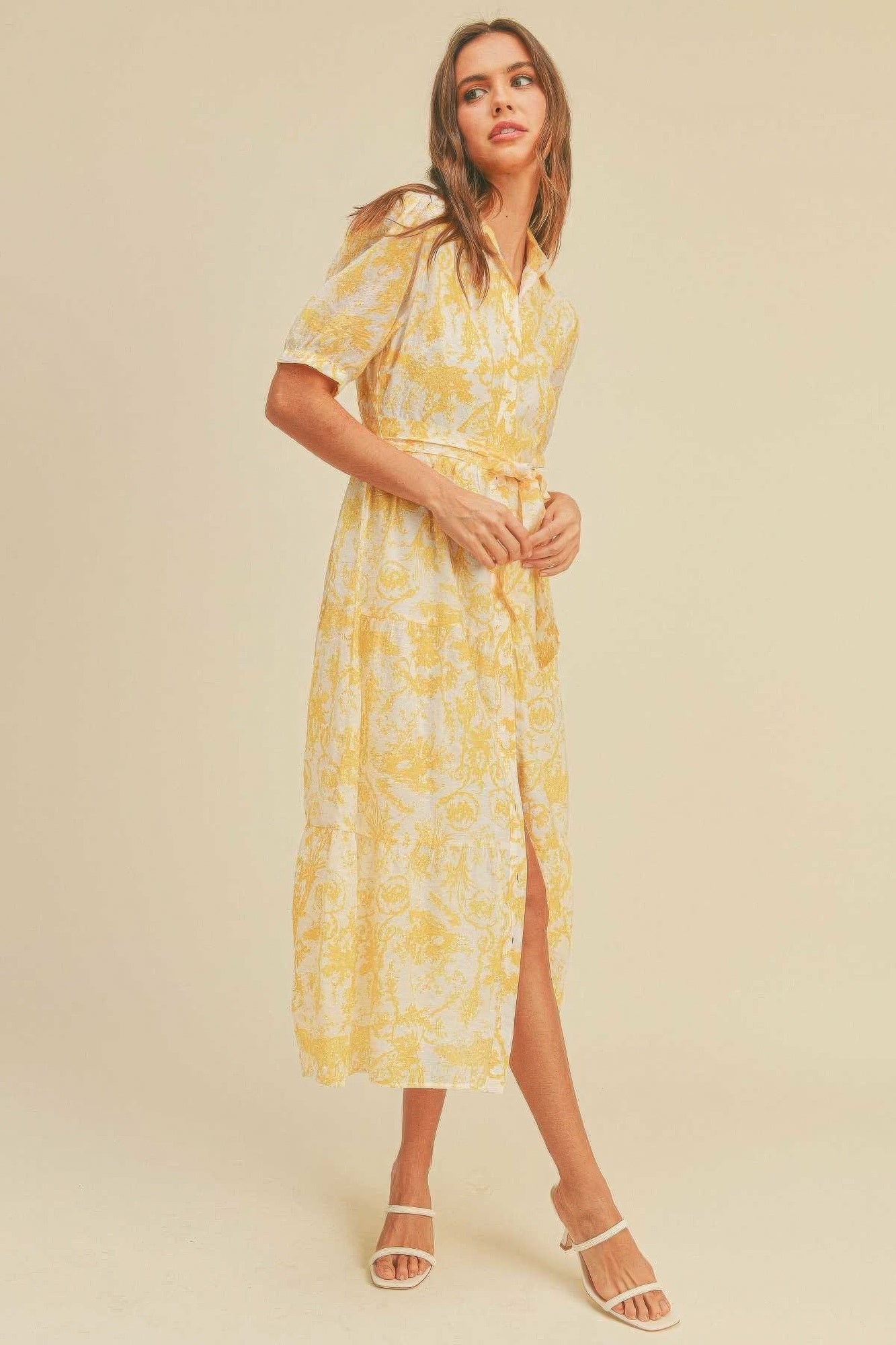 The Harper is our button closure, waist belt and puff sleeve dress. It's made of 95% polyester and 5% spandex, ensuring a comfortable and stretchy fit. The yellow colour palette creates a visually striking and cheerful look. It transitions seamlessly from casual outings to more formal occasions, making it an ideal choice for various events.