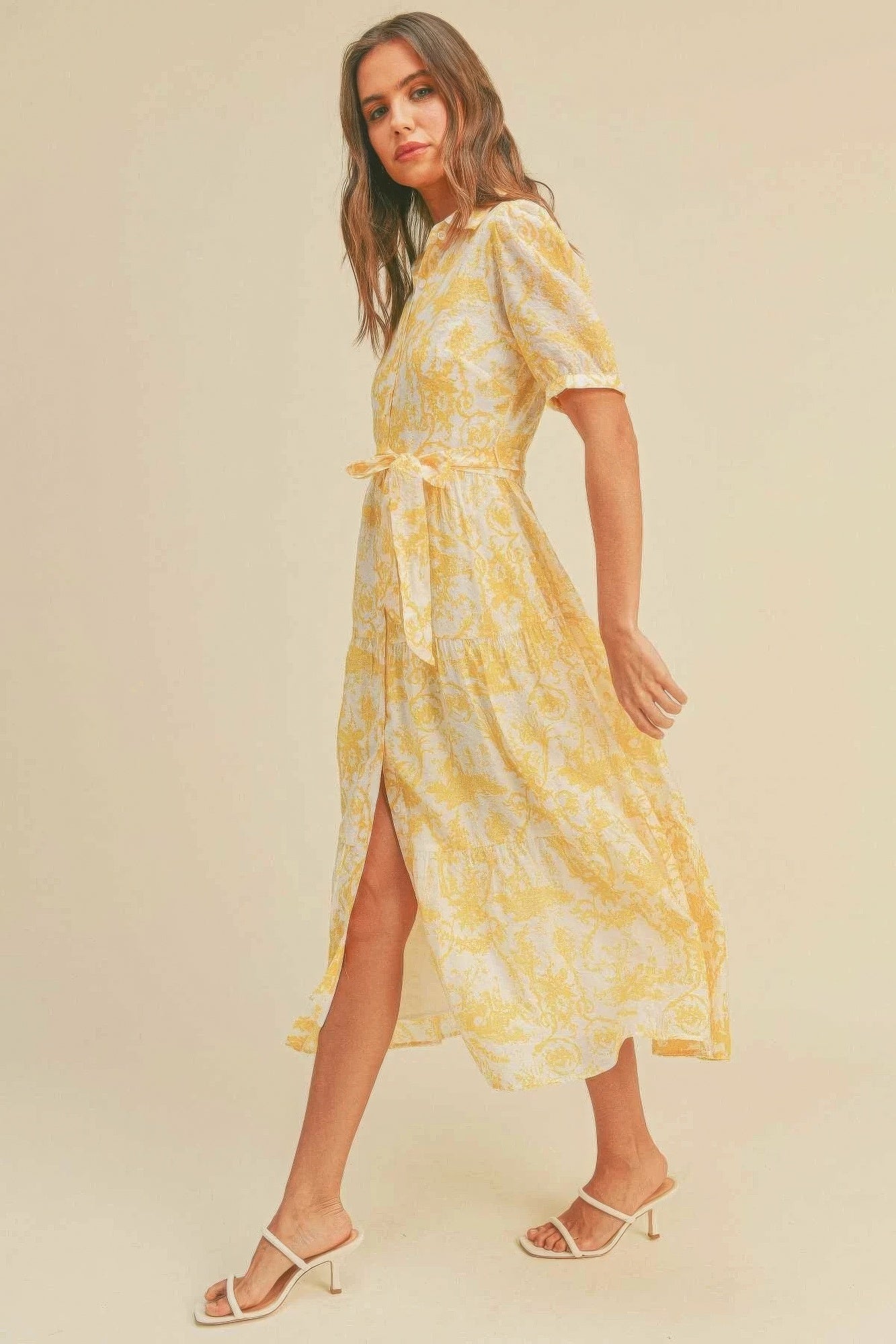 The Harper is our button closure, waist belt and puff sleeve dress. It's made of 95% polyester and 5% spandex, ensuring a comfortable and stretchy fit. The yellow colour palette creates a visually striking and cheerful look. It transitions seamlessly from casual outings to more formal occasions, making it an ideal choice for various events.