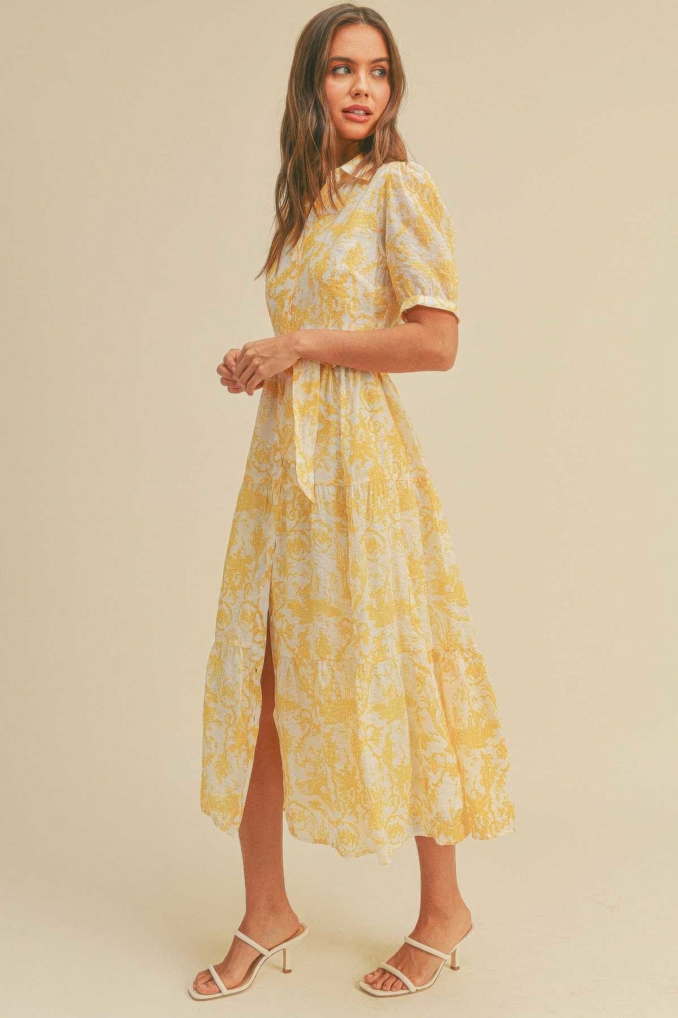 The Harper is our button closure, waist belt and puff sleeve dress. It's made of 95% polyester and 5% spandex, ensuring a comfortable and stretchy fit. The yellow colour palette creates a visually striking and cheerful look. It transitions seamlessly from casual outings to more formal occasions, making it an ideal choice for various events.