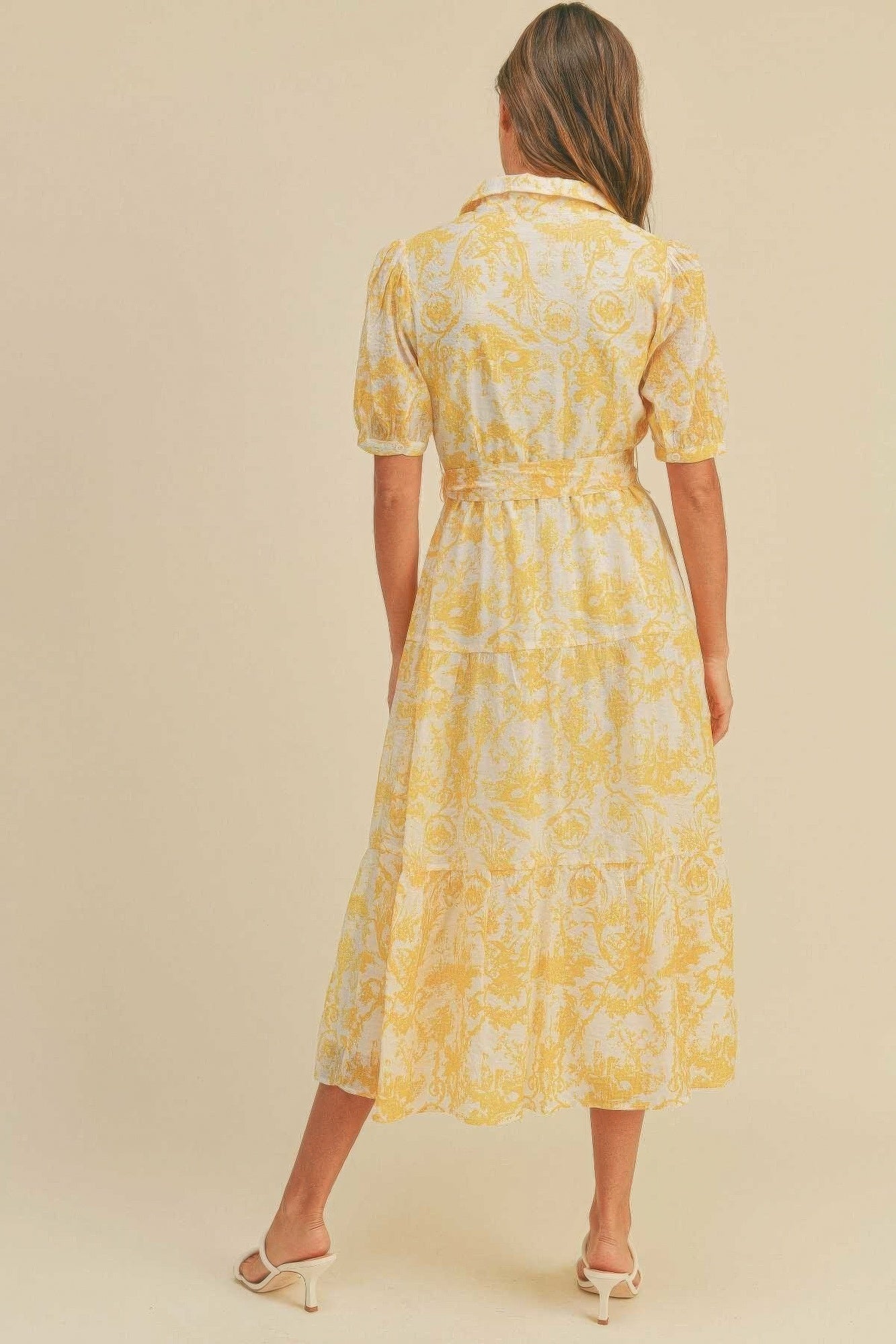 The Harper is our button closure, waist belt and puff sleeve dress. It's made of 95% polyester and 5% spandex, ensuring a comfortable and stretchy fit. The yellow colour palette creates a visually striking and cheerful look. It transitions seamlessly from casual outings to more formal occasions, making it an ideal choice for various events.