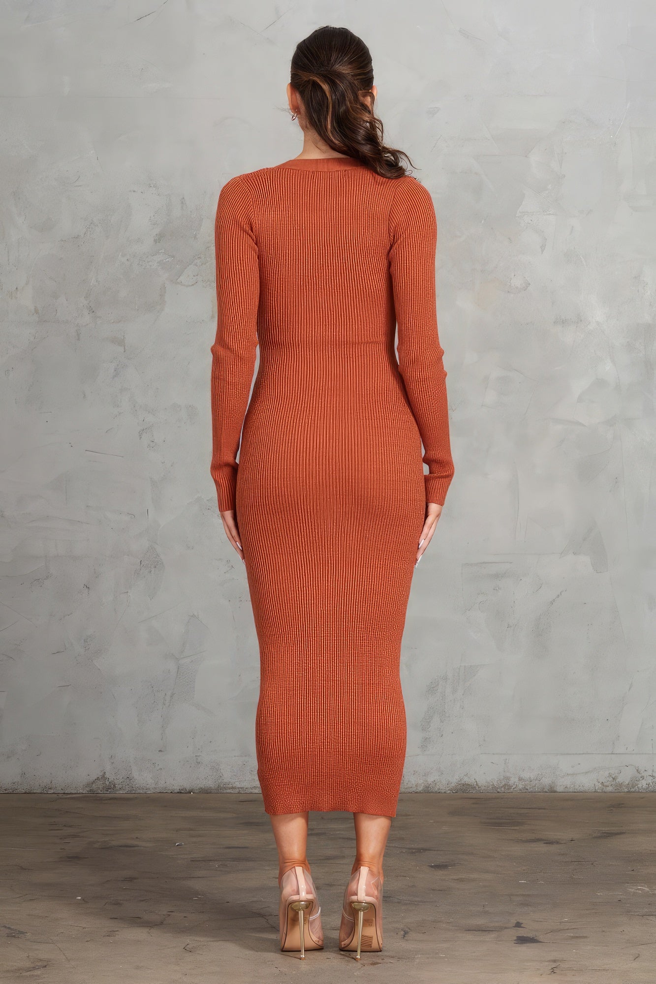 Enhance your style with The Nora, a gorgeous cognac bodycon dress. It features a button front, a V-neck, and long sleeves with thumbholes for a chic and contemporary look. Crafted from a premium blend of 43% viscose, 42% polyester, and 15% nylon, this dress offers a perfect combination of comfort and sophistication. Perfect for a night out, special events, or any occasion where you want to showcase your sophisticated style.