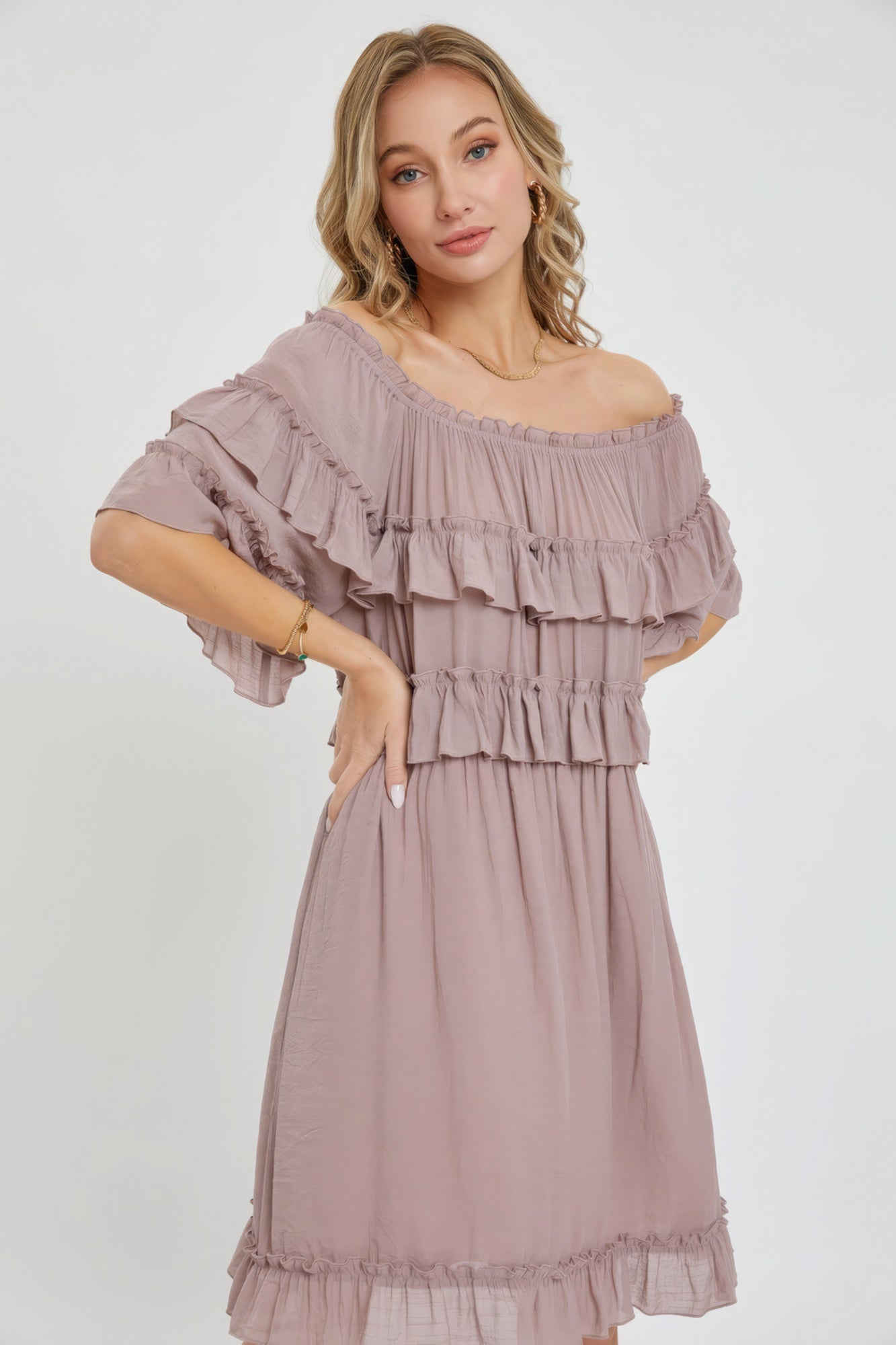 The Kayla is a relaxed-fit, bohemian-style dress that effortlessly combines elegance and comfort. This off-shoulder, short-sleeve dress features an elastic waist, a ruffle bottom, and a feminine silhouette. Crafted from 100% polyester, The Kayla is both soft and lightweight. This enchanting dark mauve dress is ideal for casual weddings, outdoor gatherings and beach vacations.