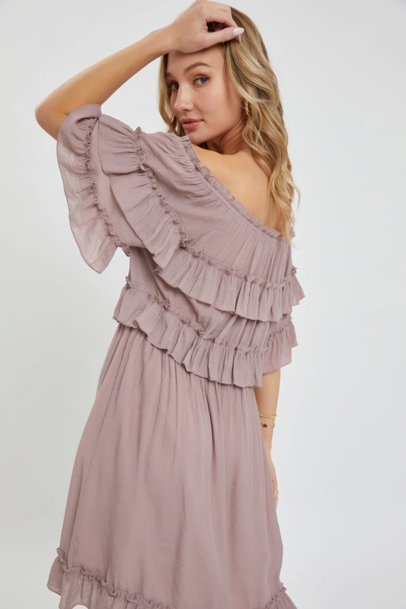 The Kayla is a relaxed-fit, bohemian-style dress that effortlessly combines elegance and comfort. This off-shoulder, short-sleeve dress features an elastic waist, a ruffle bottom, and a feminine silhouette. Crafted from 100% polyester, The Kayla is both soft and lightweight. This enchanting dark mauve dress is ideal for casual weddings, outdoor gatherings and beach vacations.