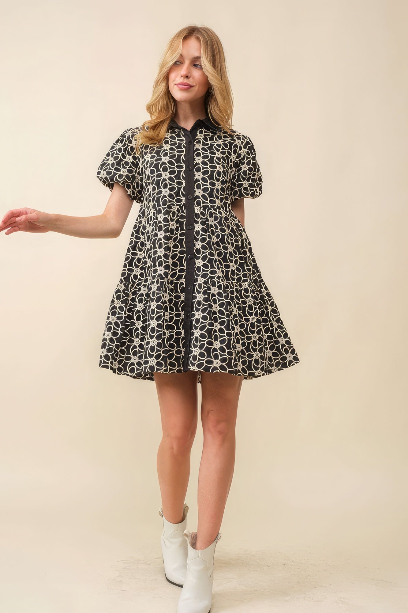 Elevate your wardrobe The Amelia, a charming and feminine piece that exudes timeless elegance. This dress features a collar neck, button-down front, and short bubble sleeves, creating a delightful and stylish silhouette. The jacquard floral pattern adds a touch of sophistication, making it the perfect choice for various occasions. Crafted with 100% cotton for a soft and lightweight feel.