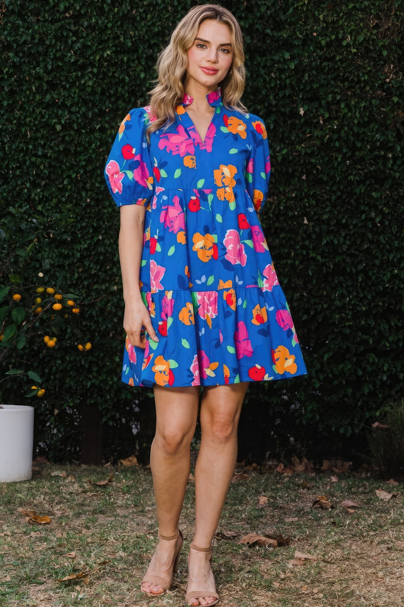 The Poppy is a charming royal blue dress that seamlessly combines style and comfort. It features a delightful floral print, complemented by a tiered silhouette, ruffle collar v-neck, and puff short sleeves for a playful yet chic look. Embrace the breathable blend of 97% Cotton and 3% Spandex that provides comfort and flexibility all day. Perfect for casual outings, brunches, or a day out with friends. Dress it up with accessories for a stylish evening look.