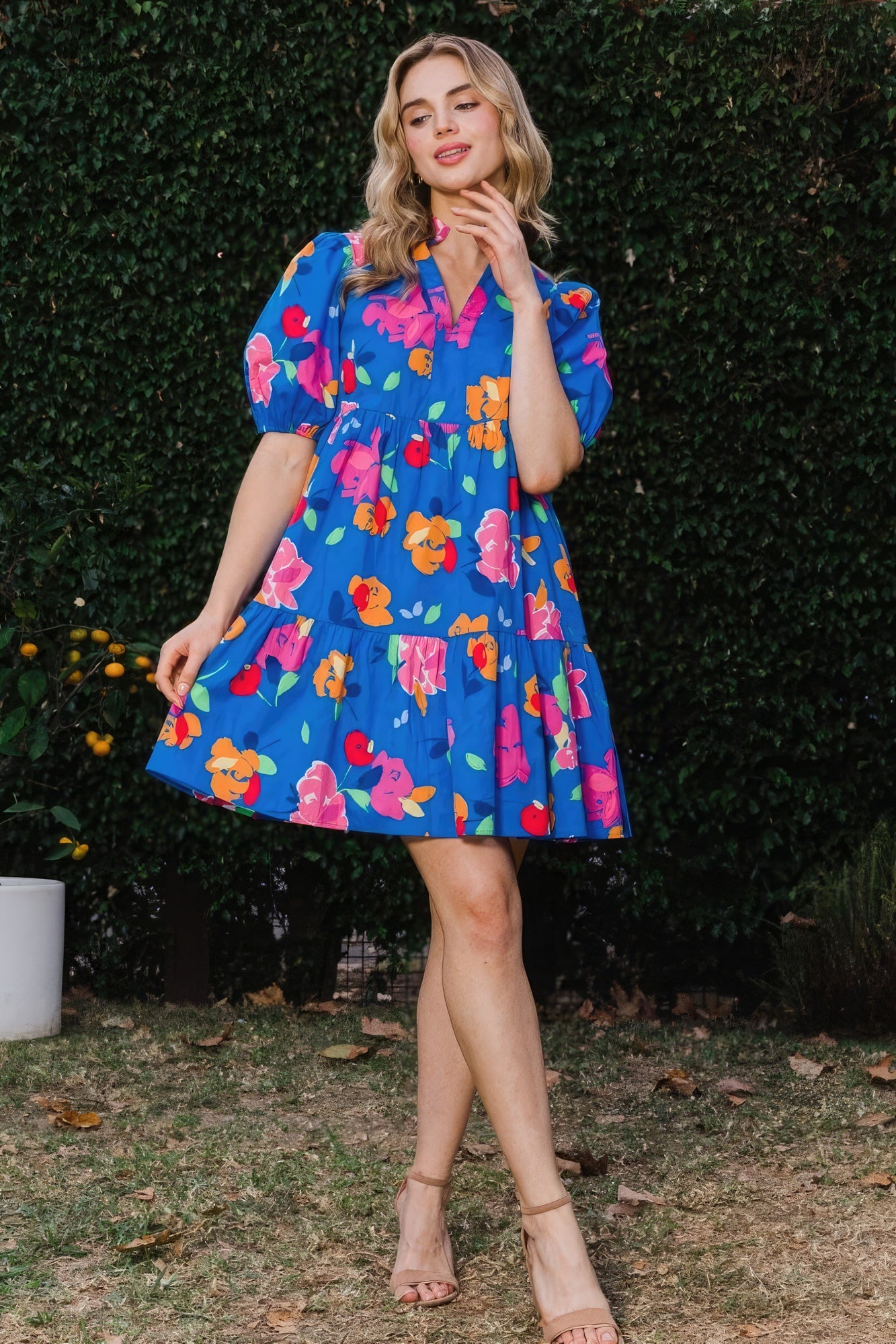 The Poppy is a charming royal blue dress that seamlessly combines style and comfort. It features a delightful floral print, complemented by a tiered silhouette, ruffle collar v-neck, and puff short sleeves for a playful yet chic look. Embrace the breathable blend of 97% Cotton and 3% Spandex that provides comfort and flexibility all day. Perfect for casual outings, brunches, or a day out with friends. Dress it up with accessories for a stylish evening look.
