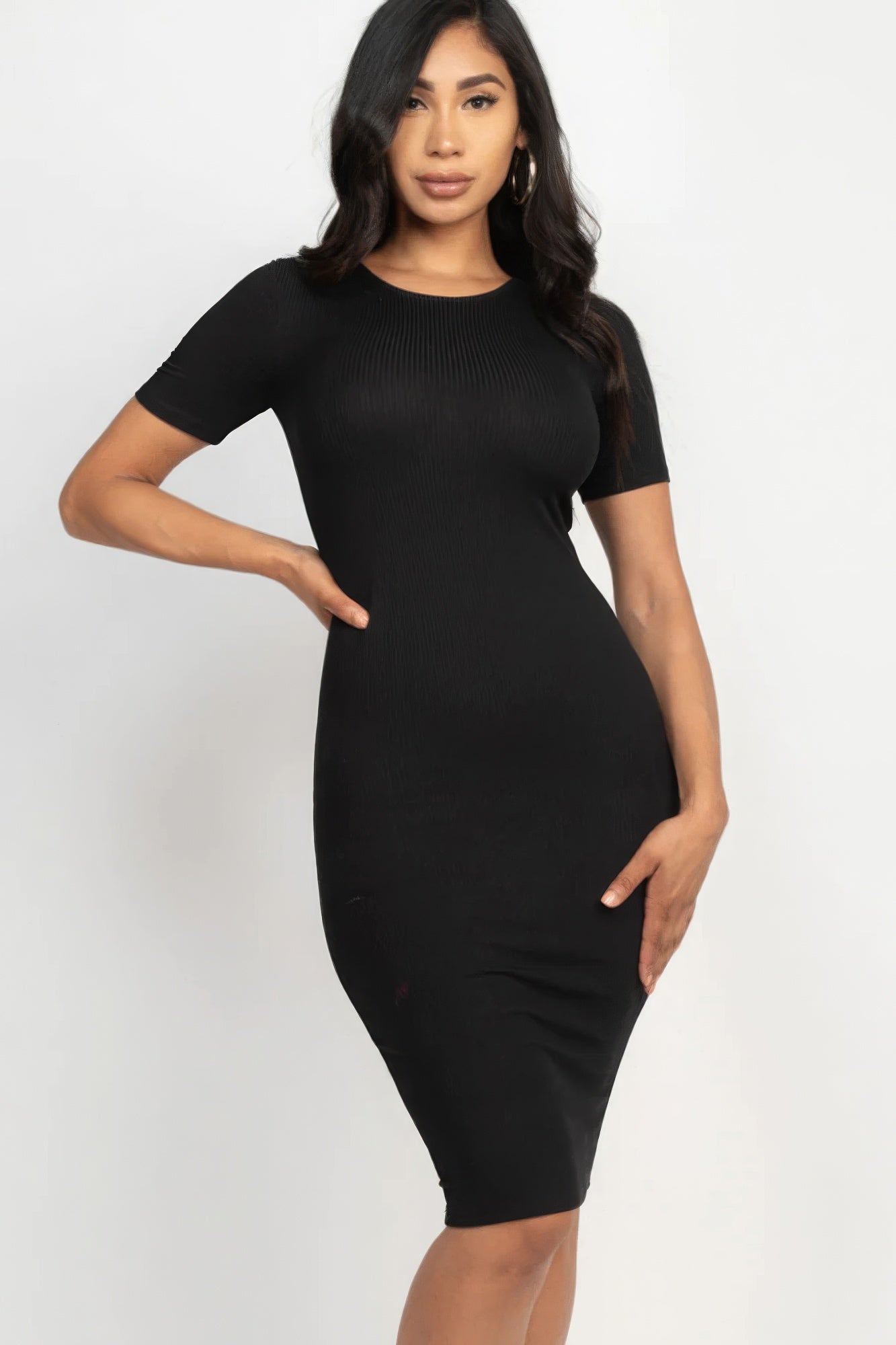 Introducing The Sarah, a sophisticated and versatile addition to your wardrobe that seamlessly combines comfort and style. This midi dress, available in a classic black colour, is crafted from a blend of 92% Polyester and 8% Spandex, to give you a flattering silhouette. Perfect for a night out, special events, or any occasion where you want to make a statement.