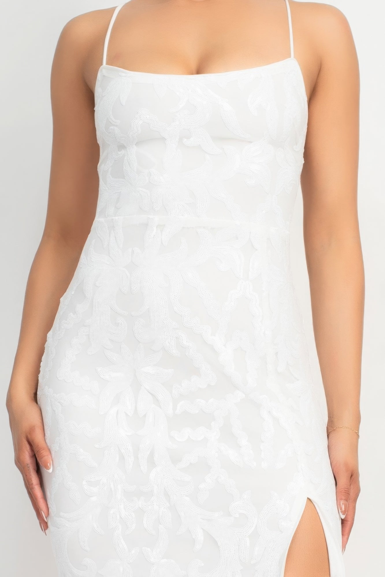The Savannah is a glamorous addition to your wardrobe. This classic couture dress in Pure White is perfect for making a statement at any special occasion. Crafted from a luxurious blend of 90% polyester and 10% spandex, this dress offers both comfort and stretch. The sequin-studded design, scoop neckline, and bodycon silhouette accentuate your curves gracefully. With its back-crisscross tie design, side slit, and maxi-length, this dress exudes glamour from every angle.