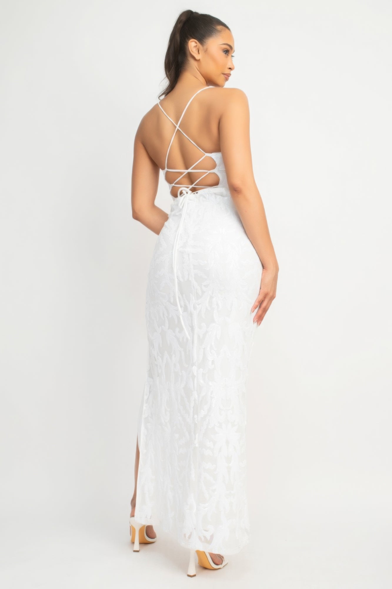 The Savannah is a glamorous addition to your wardrobe. This classic couture dress in Pure White is perfect for making a statement at any special occasion. Crafted from a luxurious blend of 90% polyester and 10% spandex, this dress offers both comfort and stretch. The sequin-studded design, scoop neckline, and bodycon silhouette accentuate your curves gracefully. With its back-crisscross tie design, side slit, and maxi-length, this dress exudes glamour from every angle.