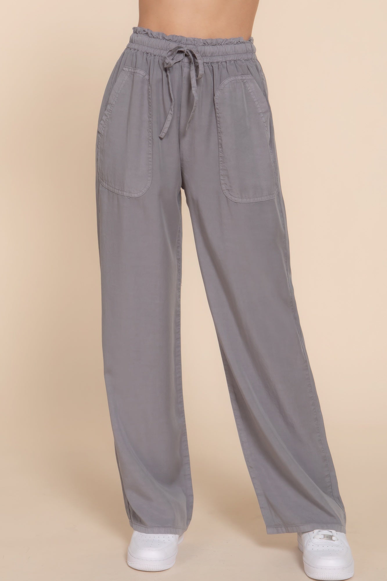 The Winona is our elastic waist Tencel fiber long pants, crafted for both comfort and style. These pants are known for their softness and sustainability. Perfect for various occasions from casual outings to relaxed work environments. Fabric: Made from 100% Tencel. Colour: grey.