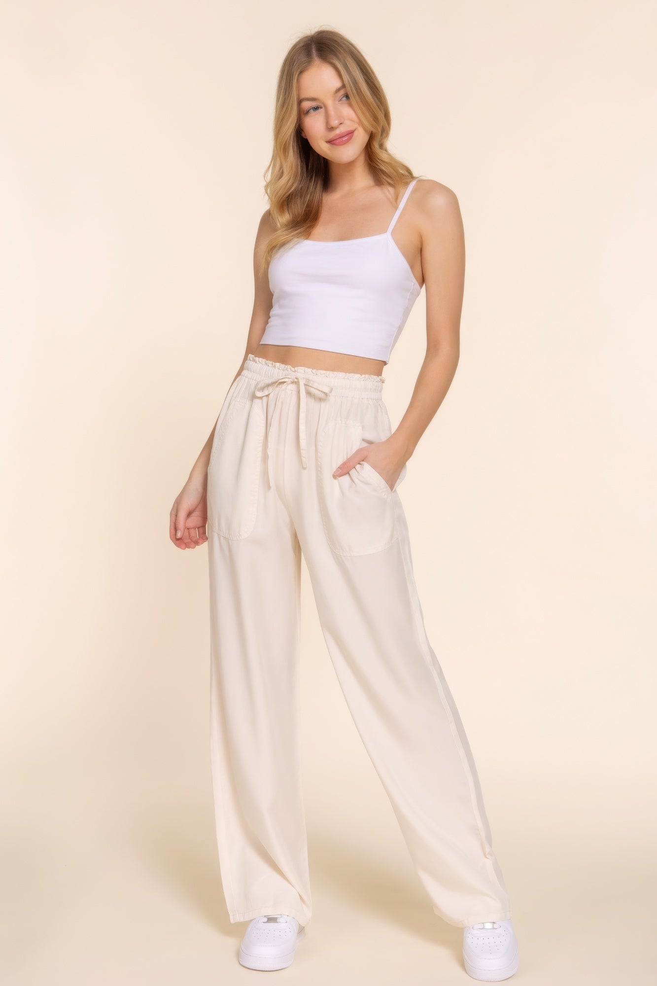 The Winona is our elastic waist Tencel fiber long pants, crafted for both comfort and style. These pants are known for their softness and sustainability. Perfect for various occasions from casual outings to relaxed work environments. Fabric: Made from 100% Tencel. Colour: beige.