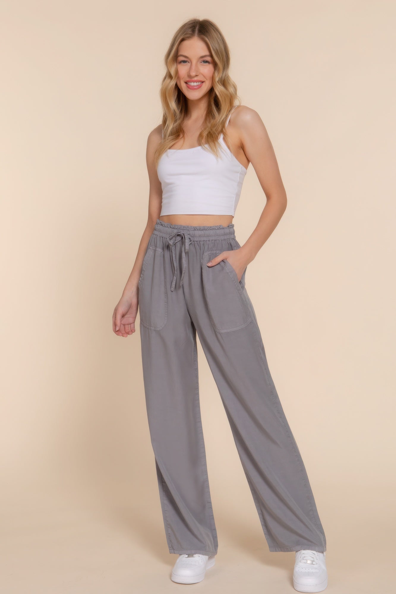 The Winona is our elastic waist Tencel fiber long pants, crafted for both comfort and style. These pants are known for their softness and sustainability. Perfect for various occasions from casual outings to relaxed work environments. Fabric: Made from 100% Tencel. Colour: grey.