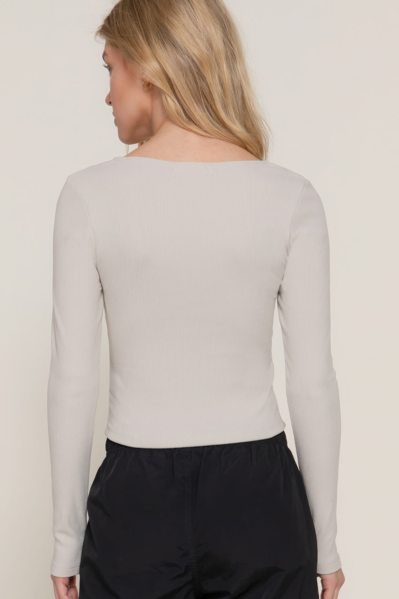Elevate your style with the Long Sleeve Sweetheart Neck Seam Detail Knit Top in classic black. This elegant top features a sweetheart neckline and detailed seam accents, making it a sophisticated addition to any wardrobe. It offers both comfort and a flattering fit. Fabric: Made from 92% polyester and 6% spandex. Silver top.