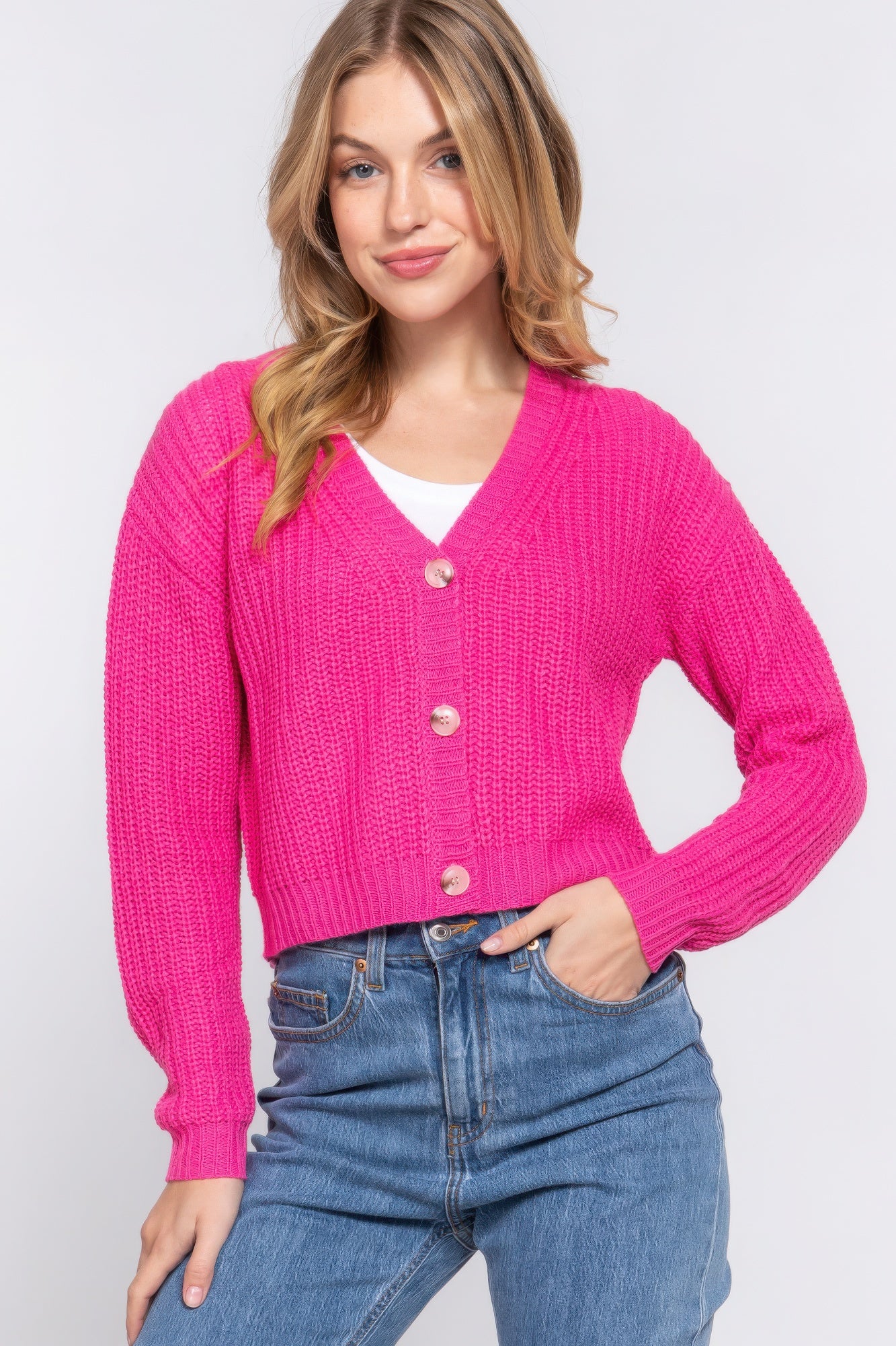 The Kate is our long sleeve v-neck cardigan. It's stylish and versatile piece with a button-down front and a relaxed fit. Ideal for layering over tops and dresses. Perfect for casual outings on cooler days. Fabric: 100% acrylic. Colour: pink.