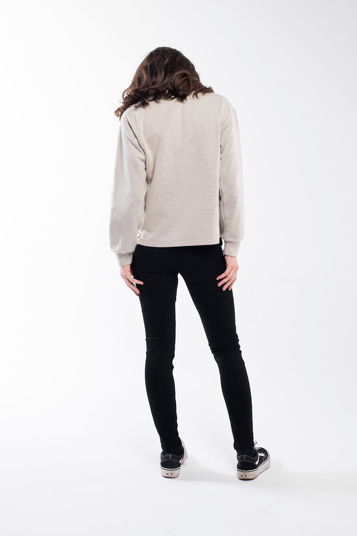 Highland Sweater - A versatile sweater made of 75% Polyester, 20% Viscose, and 5% Spandex with a buttoned high neck. This sweater offers a relaxed and comfortable fit with side slits, a regular fit, and long sleeves. It's an eco-conscious product manufactured from surplus fabrics with minimal environmental impact and a strict policy against child labor, ensuring regular employment standards are applied.