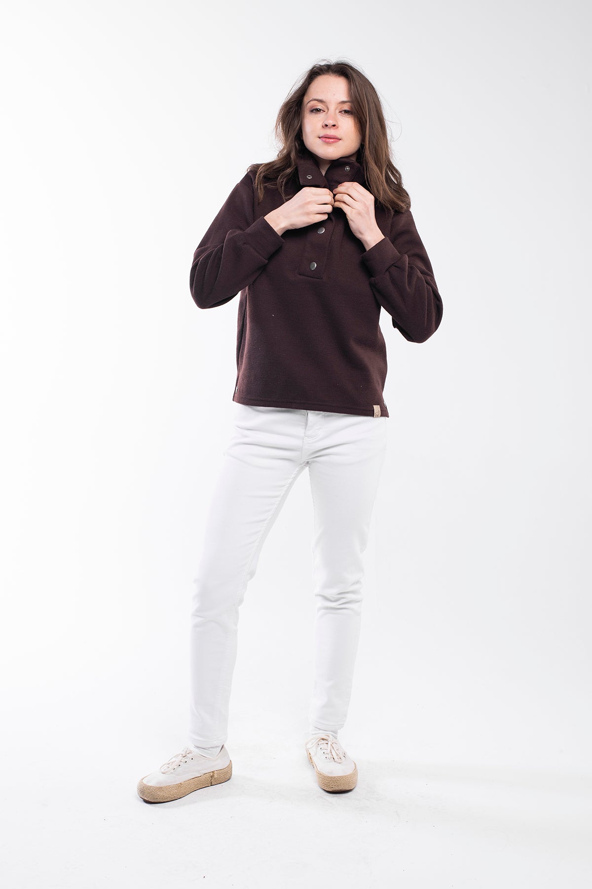 Highland Sweater - A versatile sweater made of 75% Polyester, 20% Viscose, and 5% Spandex with a buttoned high neck. This sweater offers a relaxed and comfortable fit with side slits, a regular fit, and long sleeves. It's an eco-conscious product manufactured from surplus fabrics with minimal environmental impact and a strict policy against child labor, ensuring regular employment standards are applied.