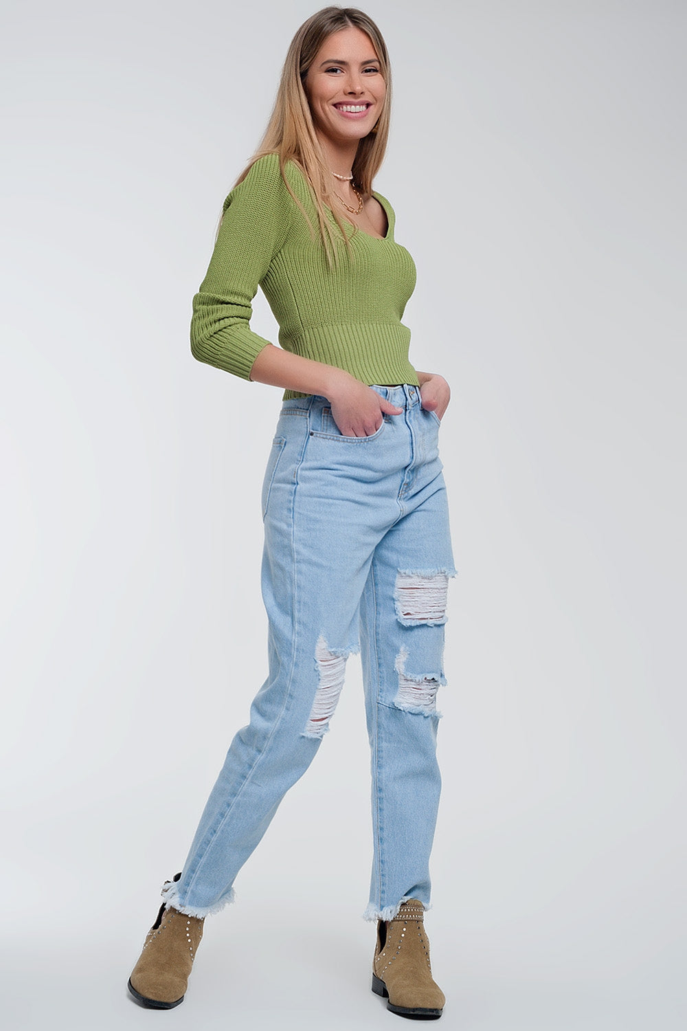 The Irina is a crochet knit jumper in green, featuring a classic crew neckline and long sleeves. This cute top runs true to size S.