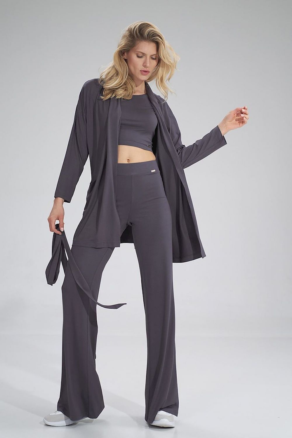 The Raven Pants is a long bell-bottom pair of trousers with a wide elastic waistband, no pockets and no zipper. It goes hand in hand with The Raven Crop Top. Colour: gray.