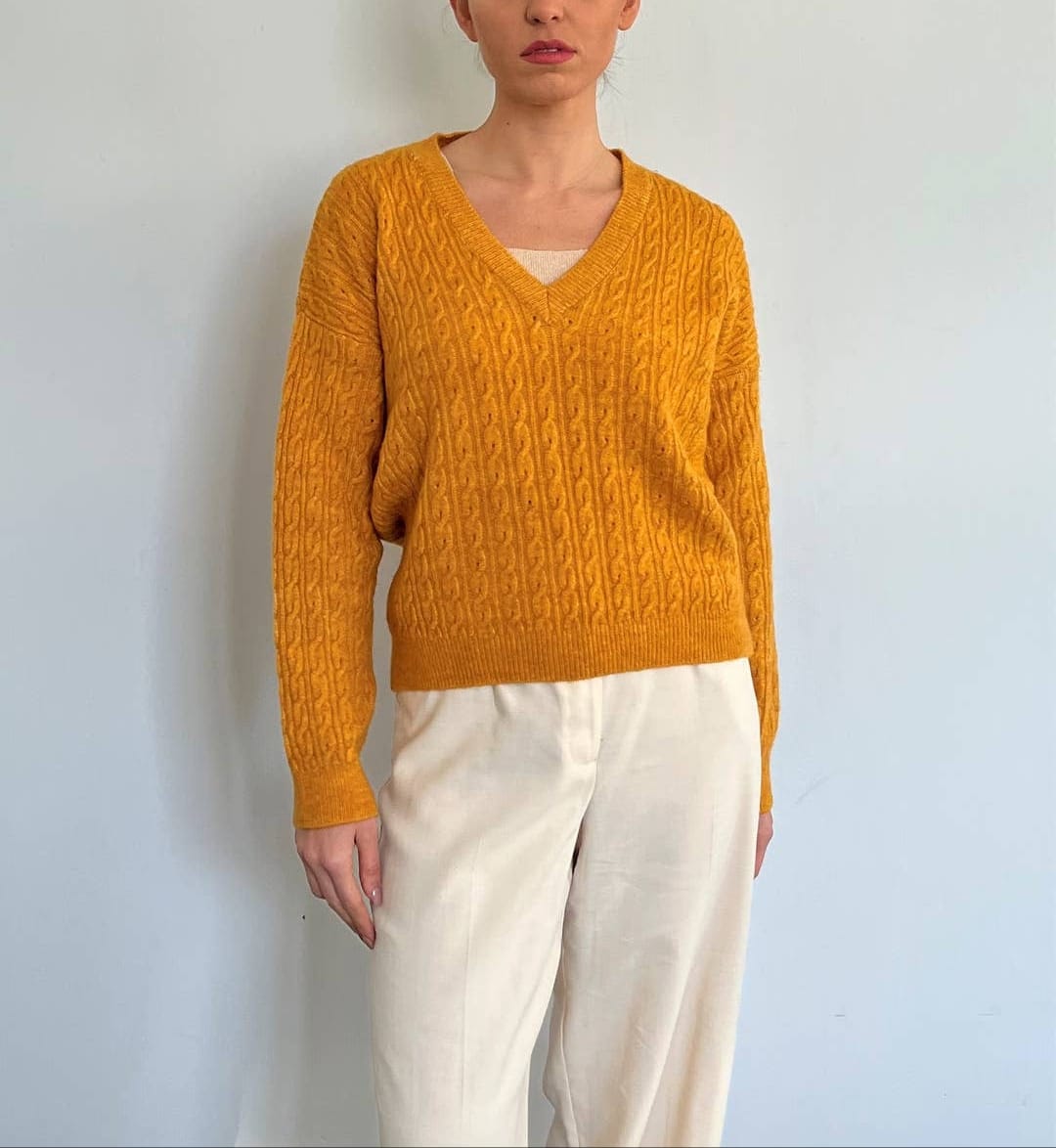 This classic sweater is available in many colors. It's easy to match with a pair of jeans or pants. An evergreen addition to your wardrobe. The is the orange colour.
