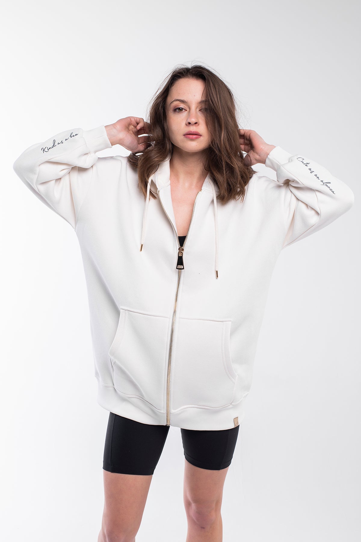 Oversized hoodie with a lined drawstring hood, front zip and kangaroo pockets for keeping your stuff secure. It has a relaxed design with dropped shoulders, long sleeves and handwriting embroidery on the wrist. This product is manufactured from surplus fabrics with minimum environmental impact where child labour is strictly prohibited and regular employment policies are applied.