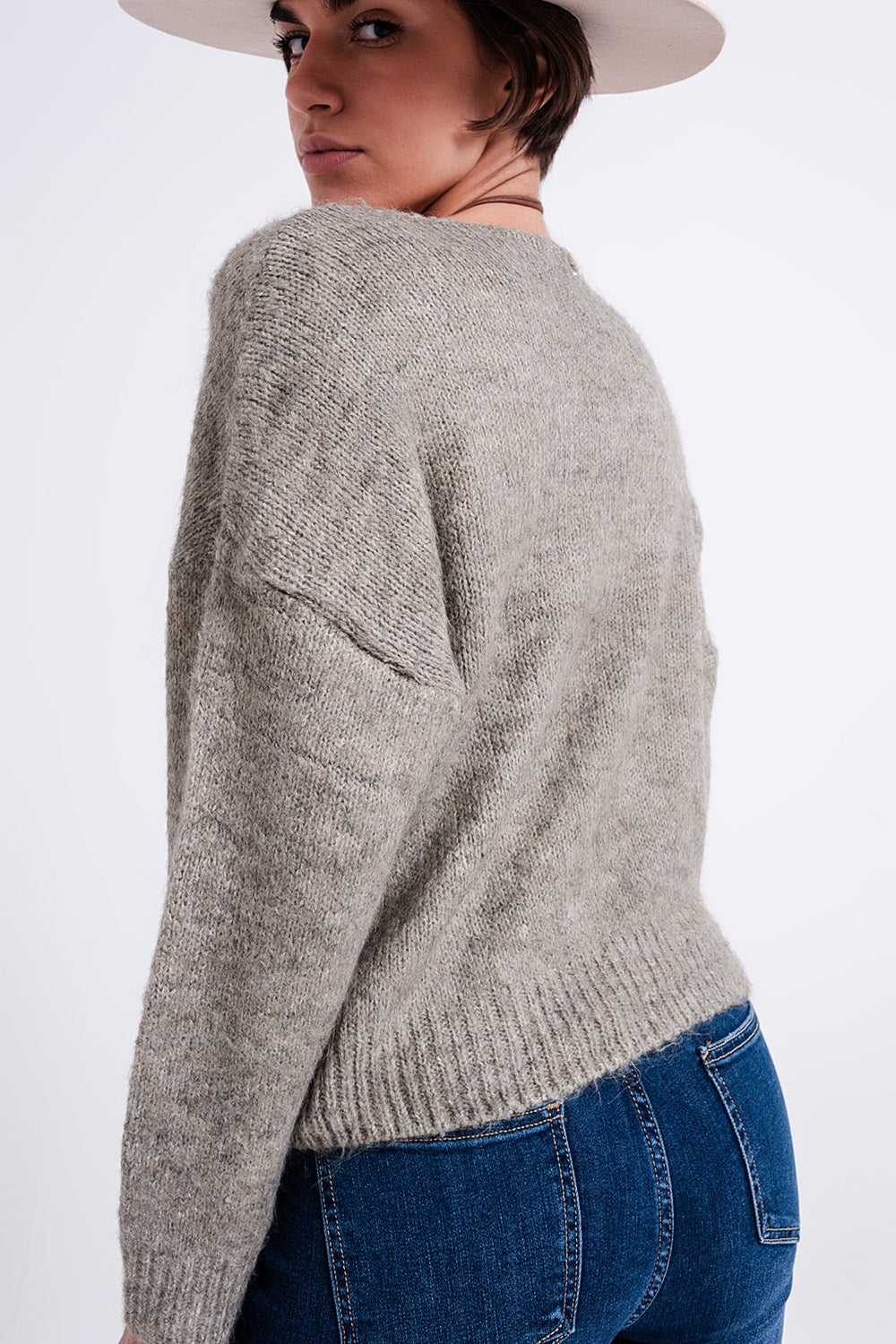 The Khaki Karma is a casual soft knit fluffy sweater with a V-neck, long sleeves and ribbed trims.