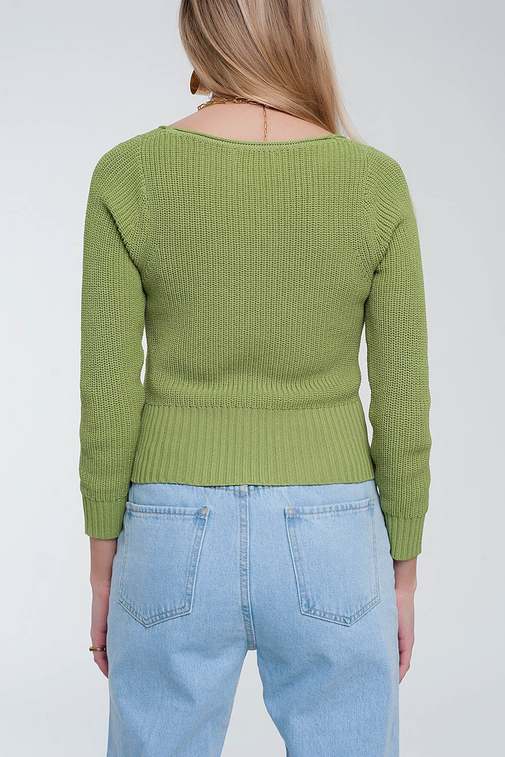 The Irina is a crochet knit jumper in green, featuring a classic crew neckline and long sleeves. This cute top runs true to size S.