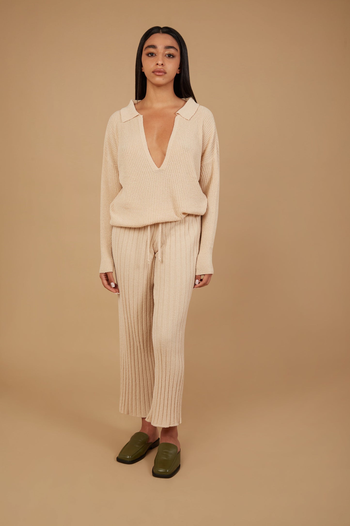 The Calypso is a tribute to the Goddess Calypso from the Odyssey. Featuring intricate ribbing, a deep V-neck, and a soft collar, this champagne coloured sweater allows for versatile wear, depending on your preferences and body shape.