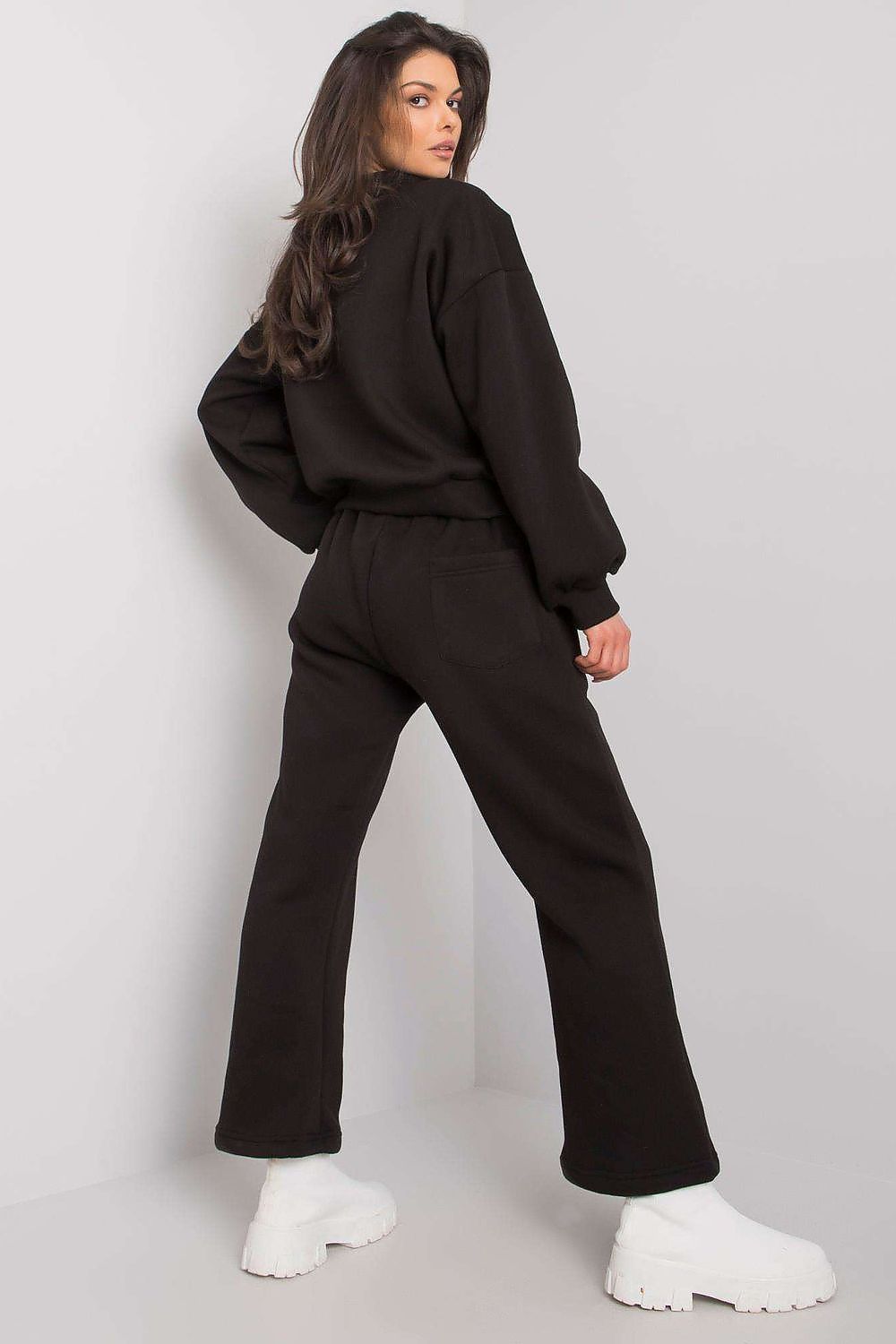 A set consisting of a black sweatshirt with long sleeves and a pocket on the front and black sweatpants with pockets and tie at waist.