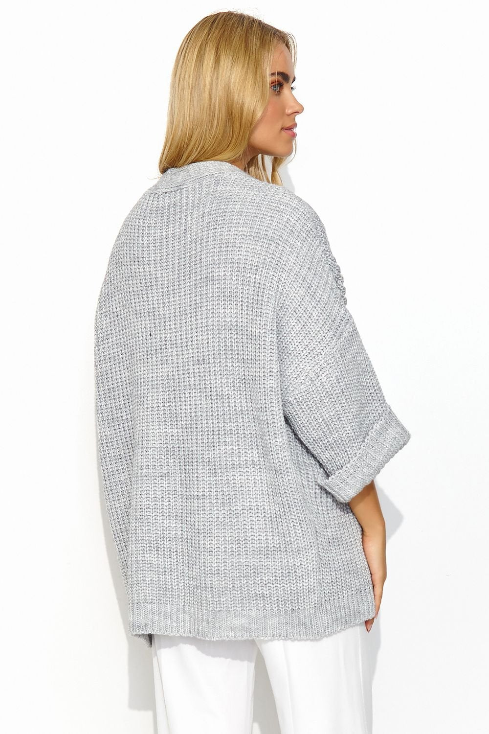 A grey buttonless cardigan with wide sleeves and a lot of character. This cardigan has a uniform and regular pattern. It looks great when paired with a dress or a simple t-shirt and jeans. It is a versatile piece that adds exceptional class to both casual and more formal outfits. Made in Europe.