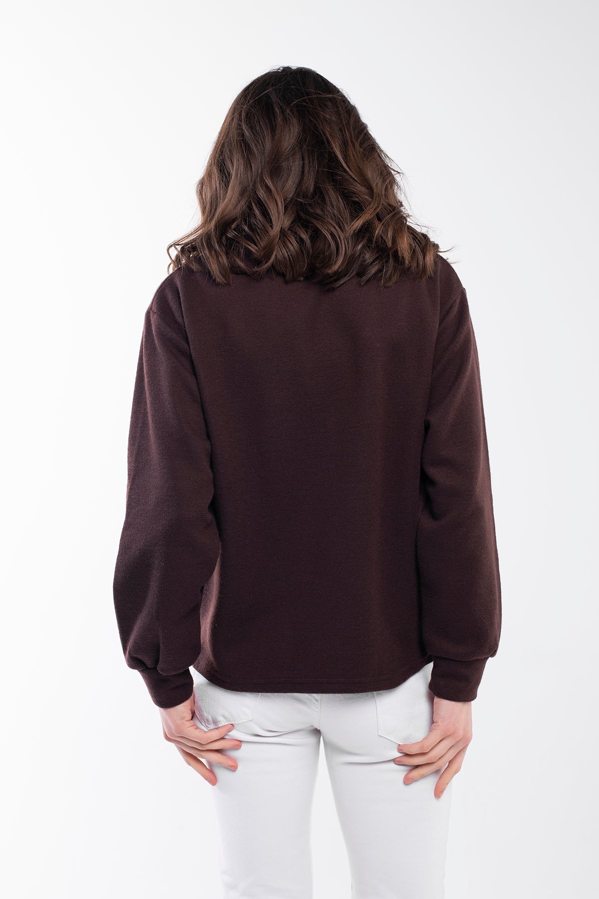 Highland Sweater - A versatile sweater made of 75% Polyester, 20% Viscose, and 5% Spandex with a buttoned high neck. This sweater offers a relaxed and comfortable fit with side slits, a regular fit, and long sleeves. It's an eco-conscious product manufactured from surplus fabrics with minimal environmental impact and a strict policy against child labor, ensuring regular employment standards are applied.