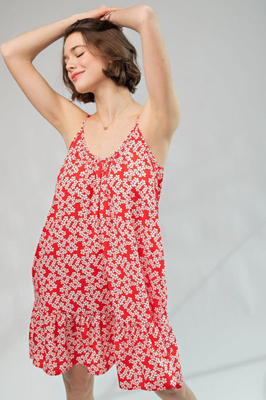 The Cassia is our floral printed wool peach cami dress, an enchanting piece that seamlessly blends floral elegance with the comfort of a loose and relaxed fit. This dress features a scoop neckline, ruffled bottom, and spaghetti straps for a touch of feminine charm. Made of 100% Polyester which provides a lightweight and breathable feel. Perfect for sunny days, casual outings, or any event where you want to exude a laid-back yet stylish vibe with a pop of confident red.