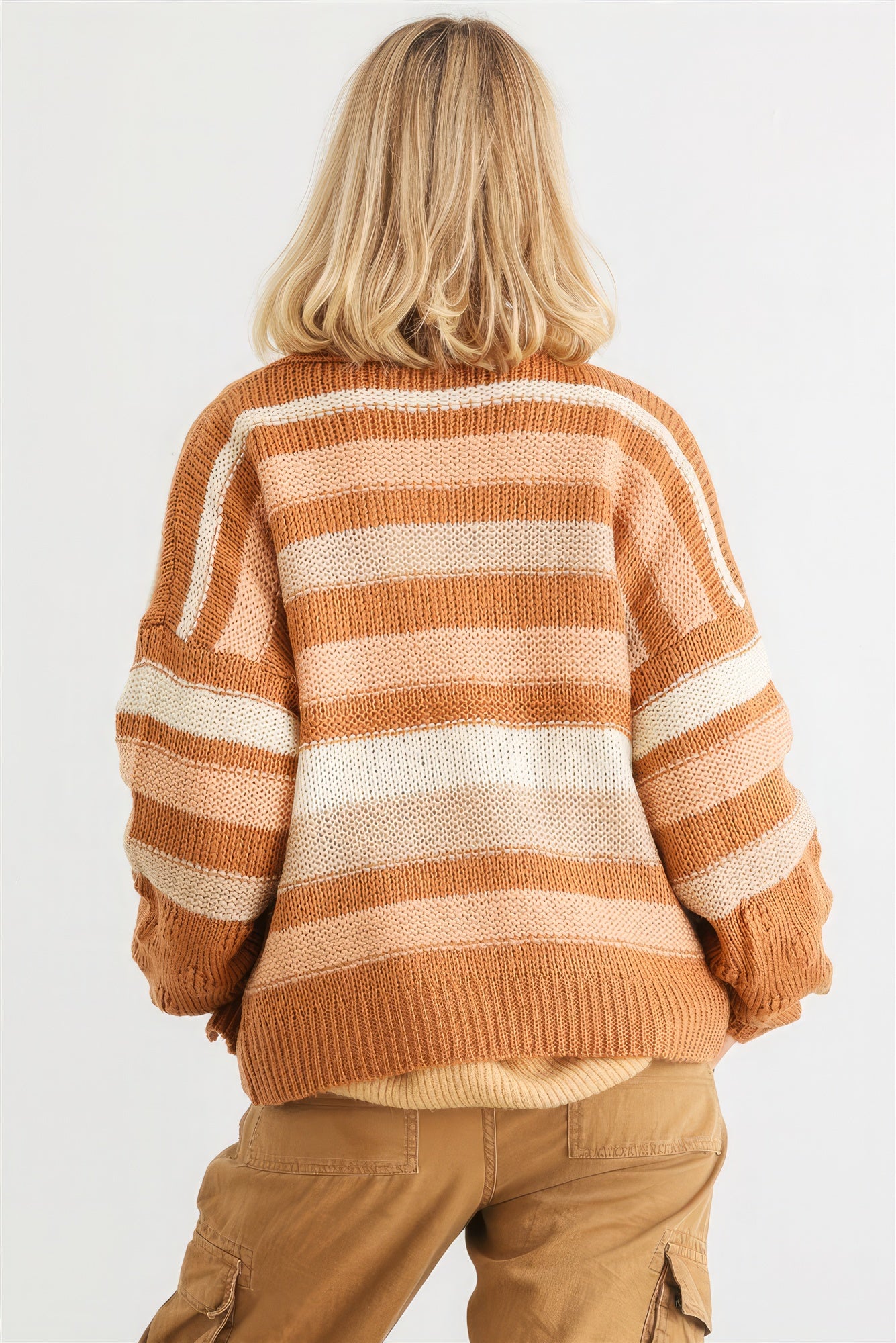 The Claire is camel our striped crochet knit cardigan. It features two pockets, a relaxed fit, dropped shoulders, and striped design for a casual stylish look. Perfect for casual outings and cozy evenings. Fabric: 90% Acrylic, 5% Polyester, and 5% Cotton.