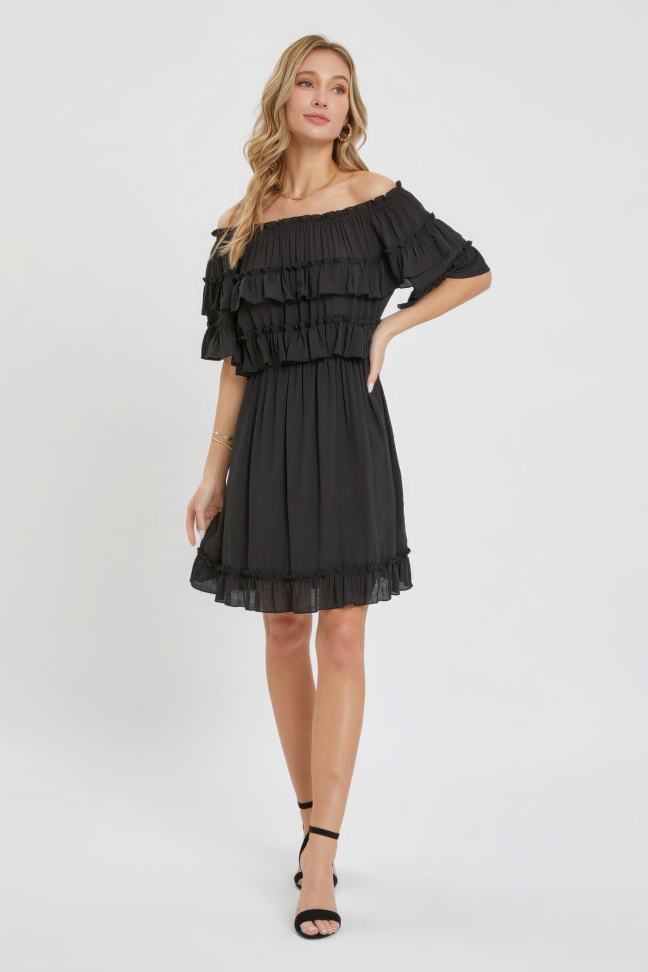 The Kayla is a relaxed-fit, bohemian-style dress that effortlessly combines elegance and comfort. This off-shoulder, short-sleeve dress features an elastic waist, a ruffle bottom, and a feminine silhouette. Crafted from 100% polyester, The Kayla is both soft and lightweight. This classic black dress is ideal for casual weddings, outdoor gatherings and beach vacations.