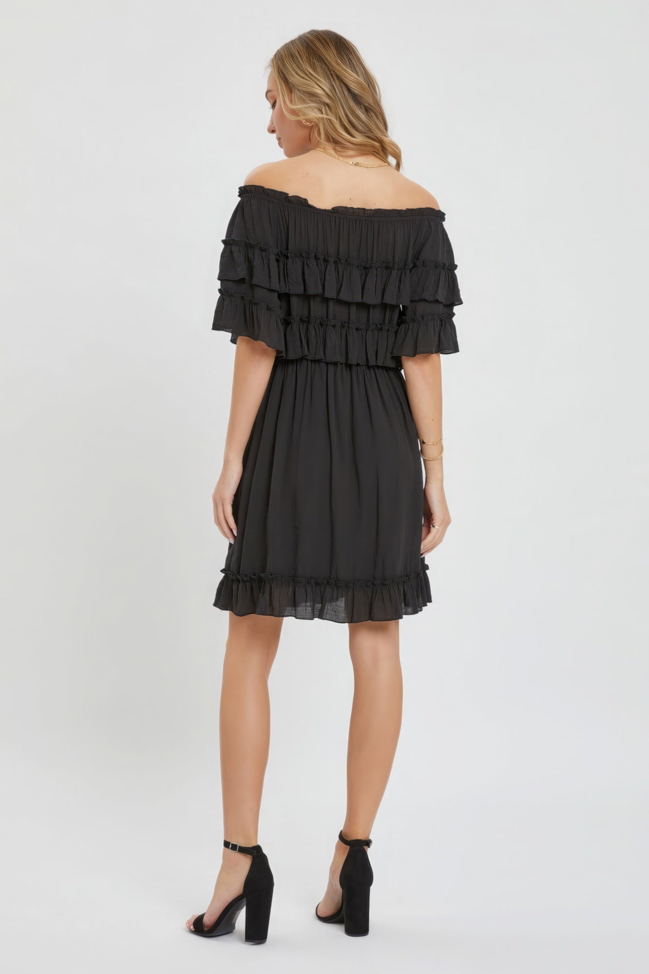 The Kayla is a relaxed-fit, bohemian-style dress that effortlessly combines elegance and comfort. This off-shoulder, short-sleeve dress features an elastic waist, a ruffle bottom, and a feminine silhouette. Crafted from 100% polyester, The Kayla is both soft and lightweight. This classic black dress is ideal for casual weddings, outdoor gatherings and beach vacations.