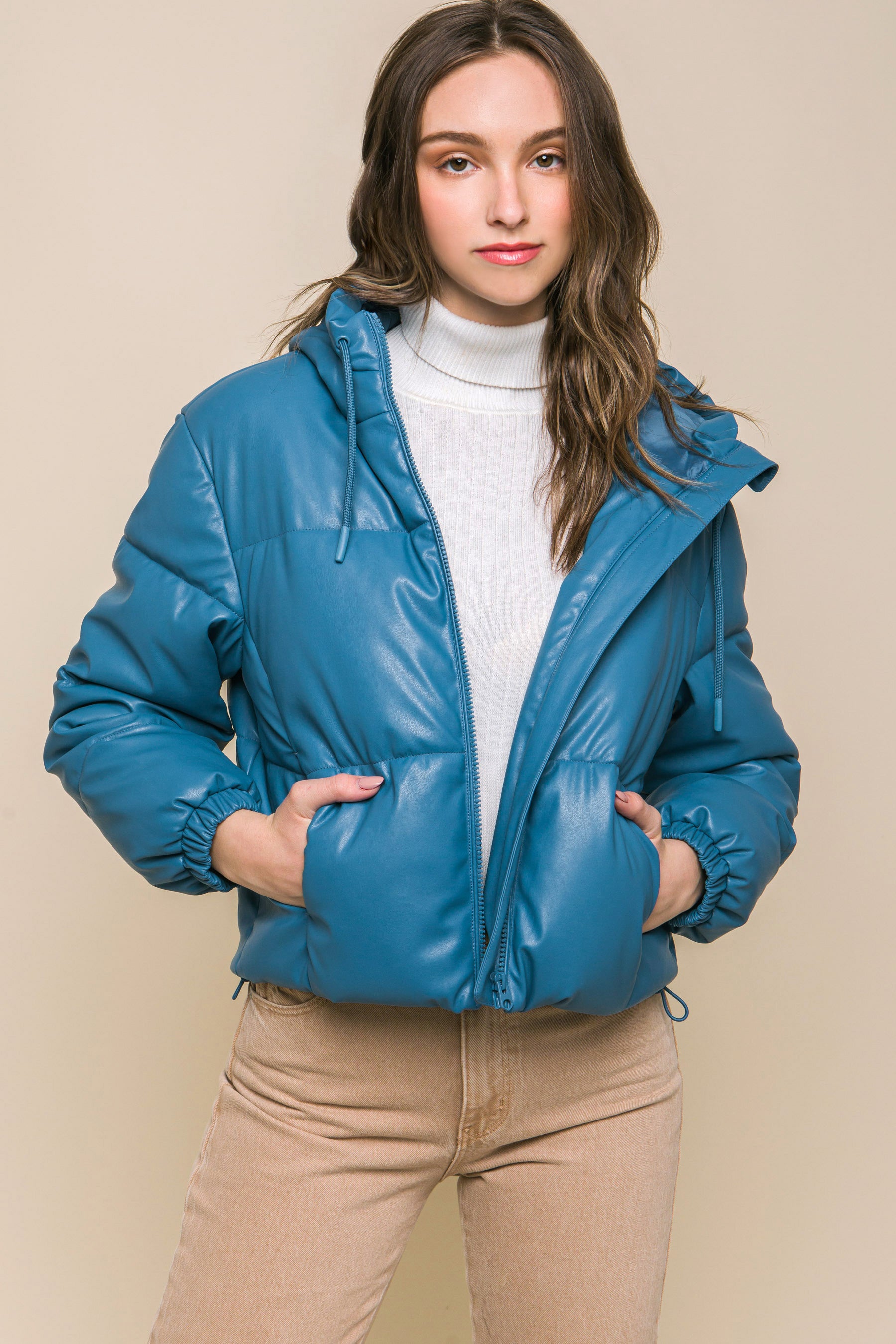 The Celine is our faux leather hooded puffer jacket. Tailored for maximum comfort, this jacket is perfect for all-day wear. Whether you're heading to a casual outing or for a night out downtown, this jacket is a versatile choice for any occasion. Fabric: Crafted from 100% Polyurethane Faux Leather. Colour: azure.