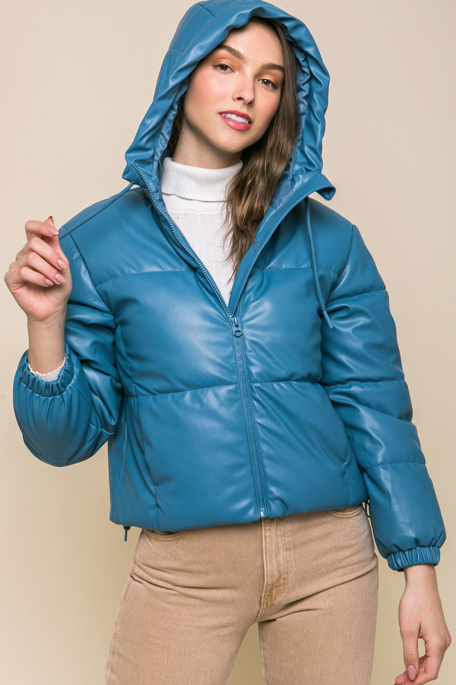 The Celine is our faux leather hooded puffer jacket. Tailored for maximum comfort, this jacket is perfect for all-day wear. Whether you're heading to a casual outing or for a night out downtown, this jacket is a versatile choice for any occasion. Fabric: Crafted from 100% Polyurethane Faux Leather. Colour: azure.