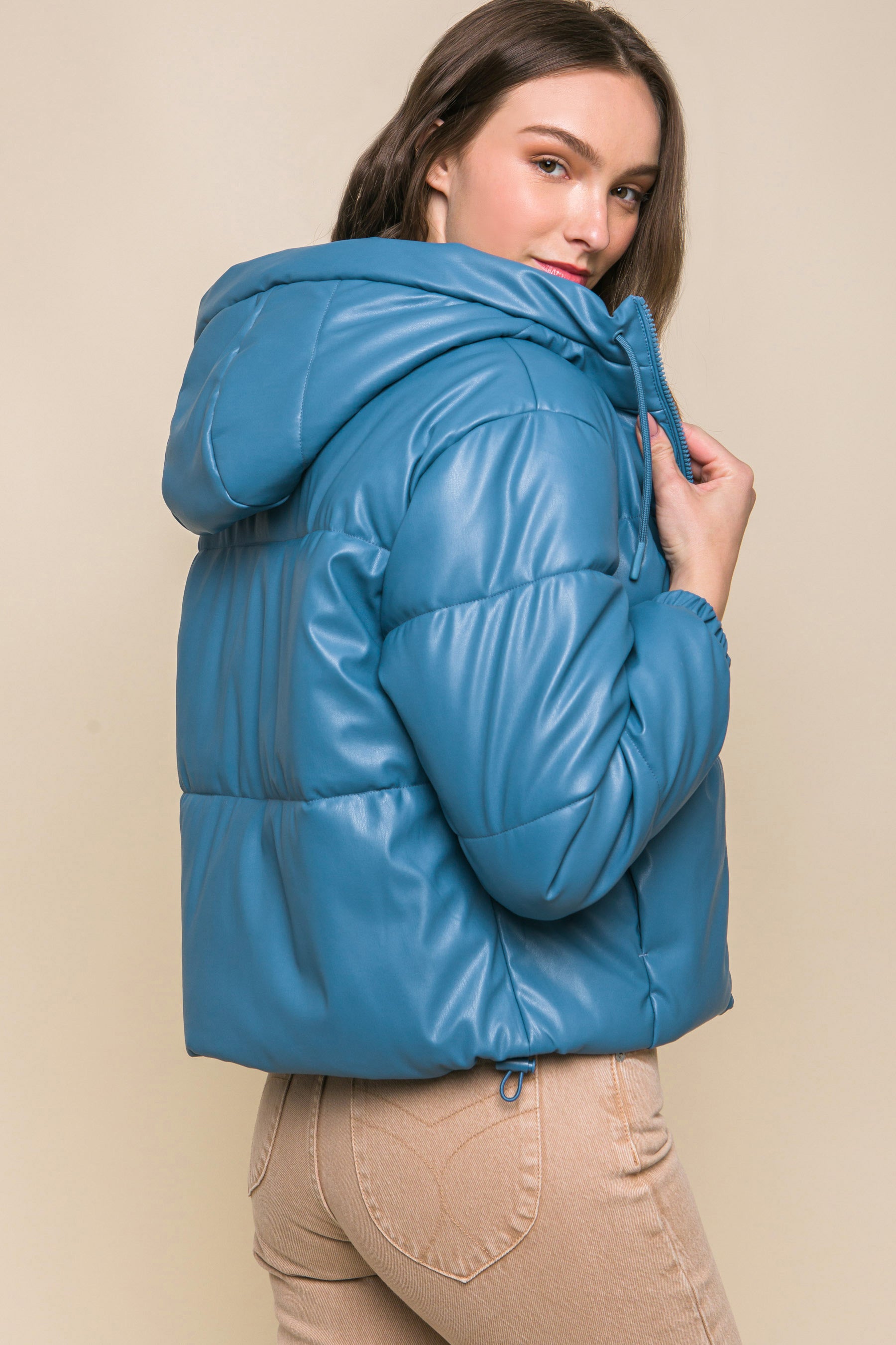 The Celine is our faux leather hooded puffer jacket. Tailored for maximum comfort, this jacket is perfect for all-day wear. Whether you're heading to a casual outing or for a night out downtown, this jacket is a versatile choice for any occasion. Fabric: Crafted from 100% Polyurethane Faux Leather. Colour: azure.