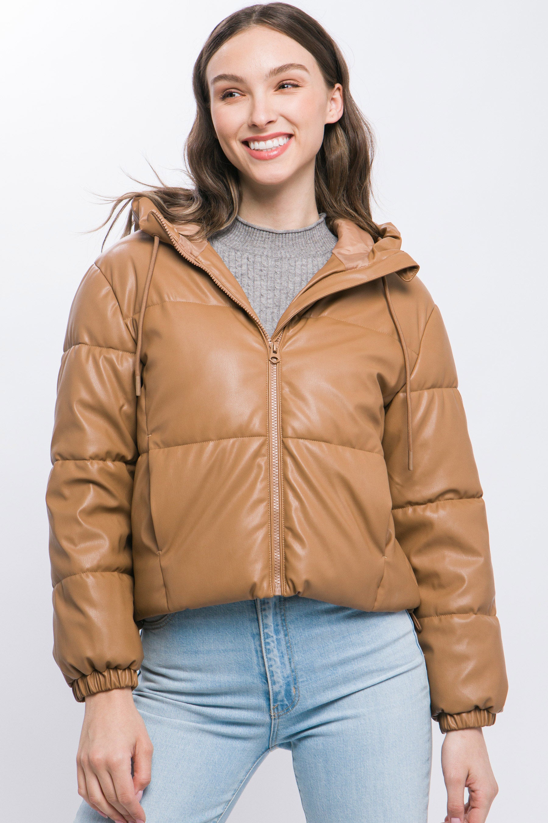 The Celine is our faux leather hooded puffer jacket. Tailored for maximum comfort, this jacket is perfect for all-day wear. Whether you're heading to a casual outing or for a night out downtown, this jacket is a versatile choice for any occasion. Fabric: Crafted from 100% Polyurethane Faux Leather. Colour: camel.