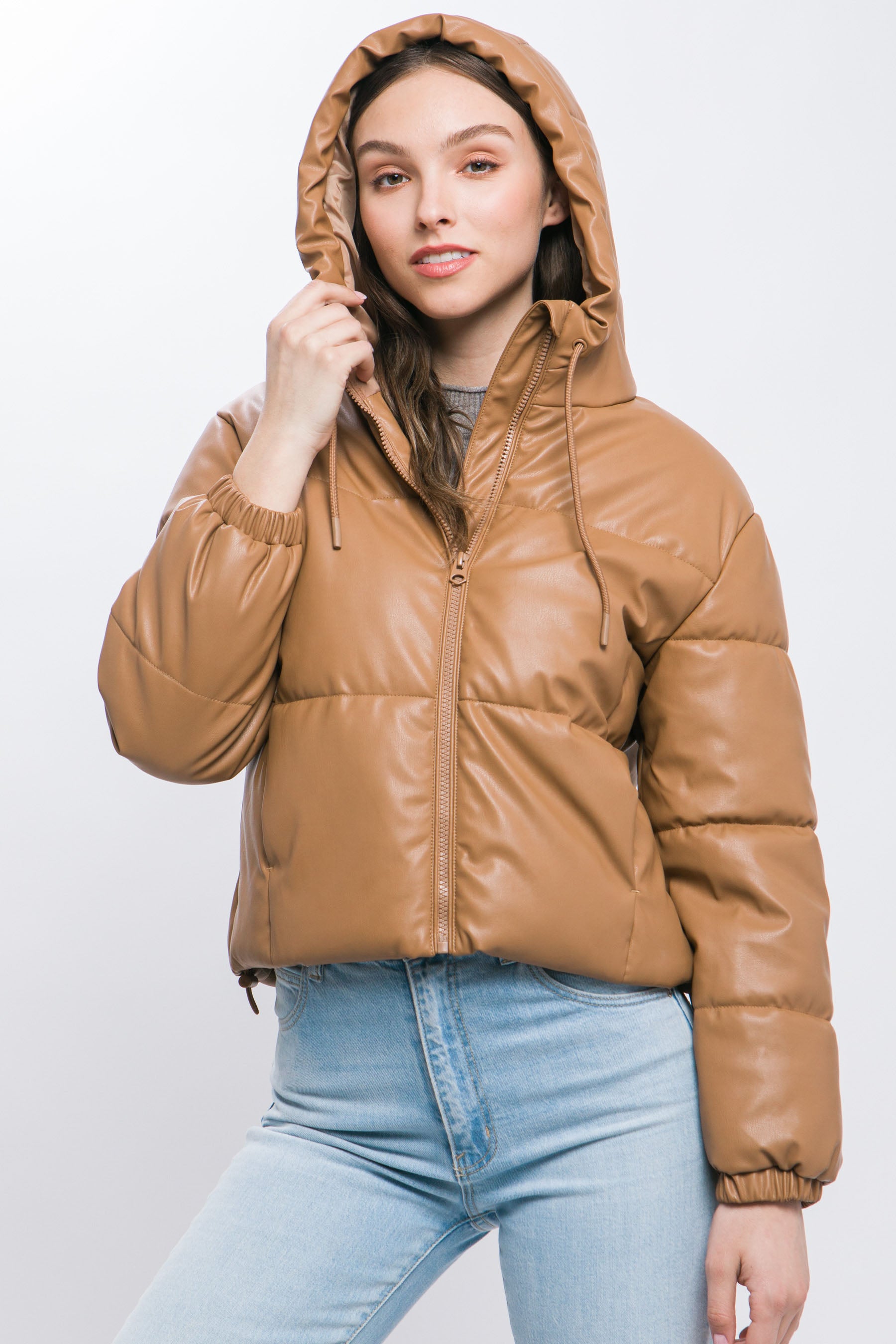 The Celine is our faux leather hooded puffer jacket. Tailored for maximum comfort, this jacket is perfect for all-day wear. Whether you're heading to a casual outing or for a night out downtown, this jacket is a versatile choice for any occasion. Fabric: Crafted from 100% Polyurethane Faux Leather. Colour: camel.