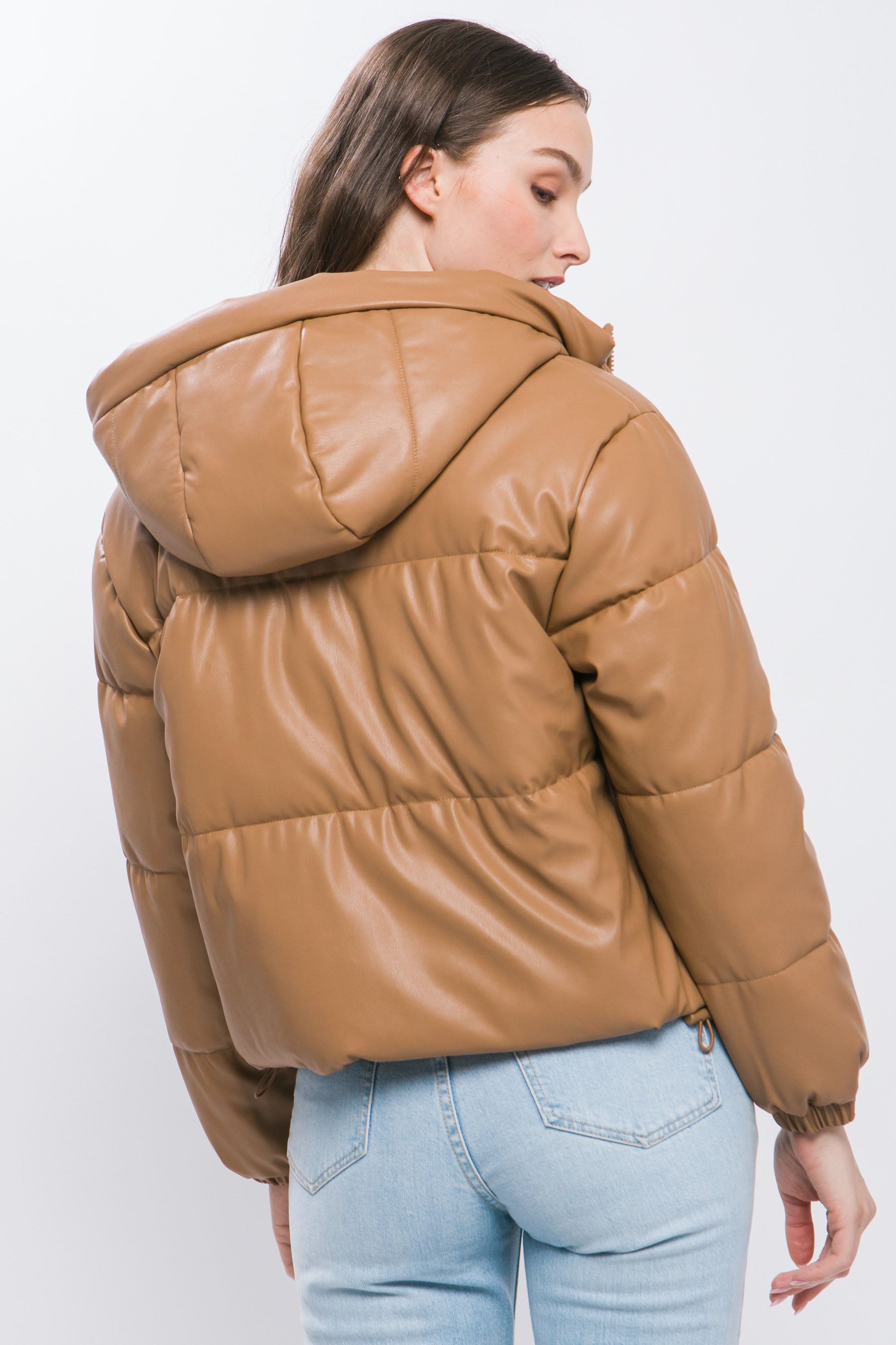 The Celine is our faux leather hooded puffer jacket. Tailored for maximum comfort, this jacket is perfect for all-day wear. Whether you're heading to a casual outing or for a night out downtown, this jacket is a versatile choice for any occasion. Fabric: Crafted from 100% Polyurethane Faux Leather. Colour: camel.