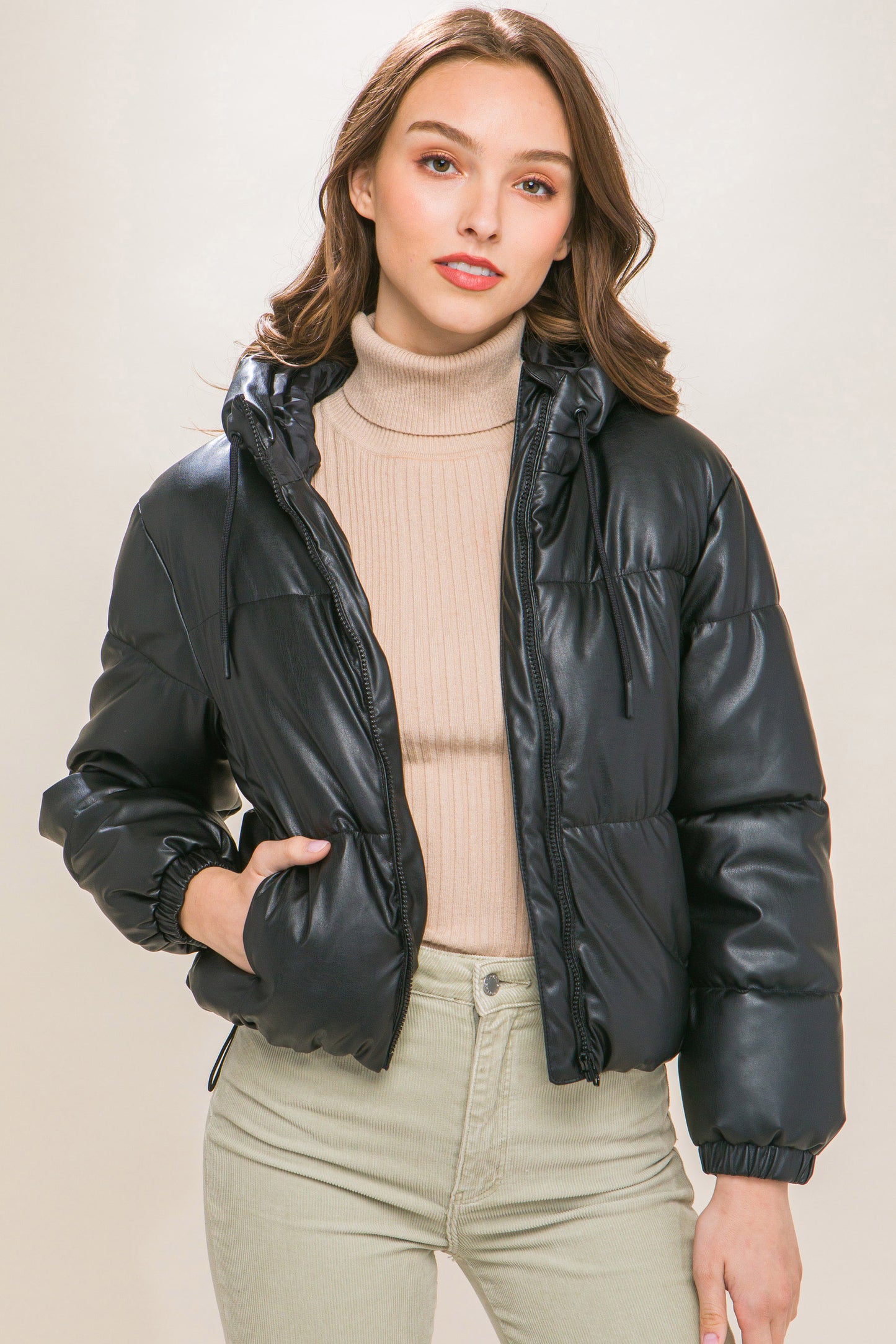 The Celine is our faux leather hooded puffer jacket. Tailored for maximum comfort, this jacket is perfect for all-day wear. Whether you're heading to a casual outing or for a night out downtown, this jacket is a versatile choice for any occasion. Fabric: Crafted from 100% Polyurethane Faux Leather. Colour: black.