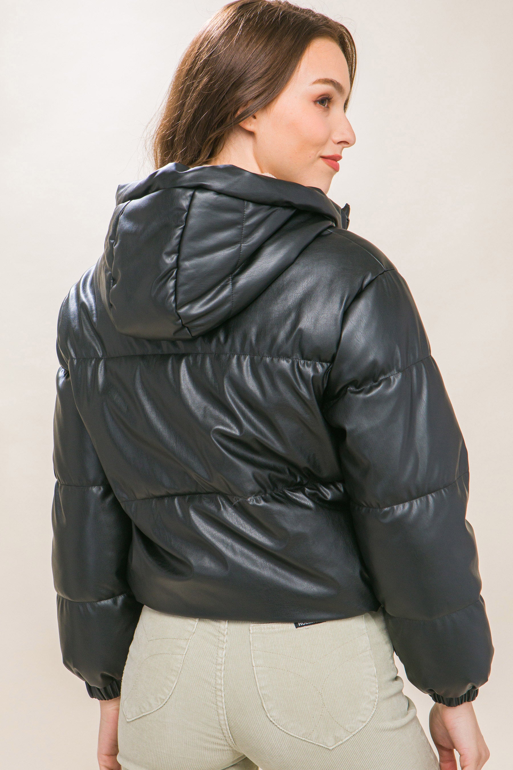 The Celine is our faux leather hooded puffer jacket. Tailored for maximum comfort, this jacket is perfect for all-day wear. Whether you're heading to a casual outing or for a night out downtown, this jacket is a versatile choice for any occasion. Fabric: Crafted from 100% Polyurethane Faux Leather. Colour: black.