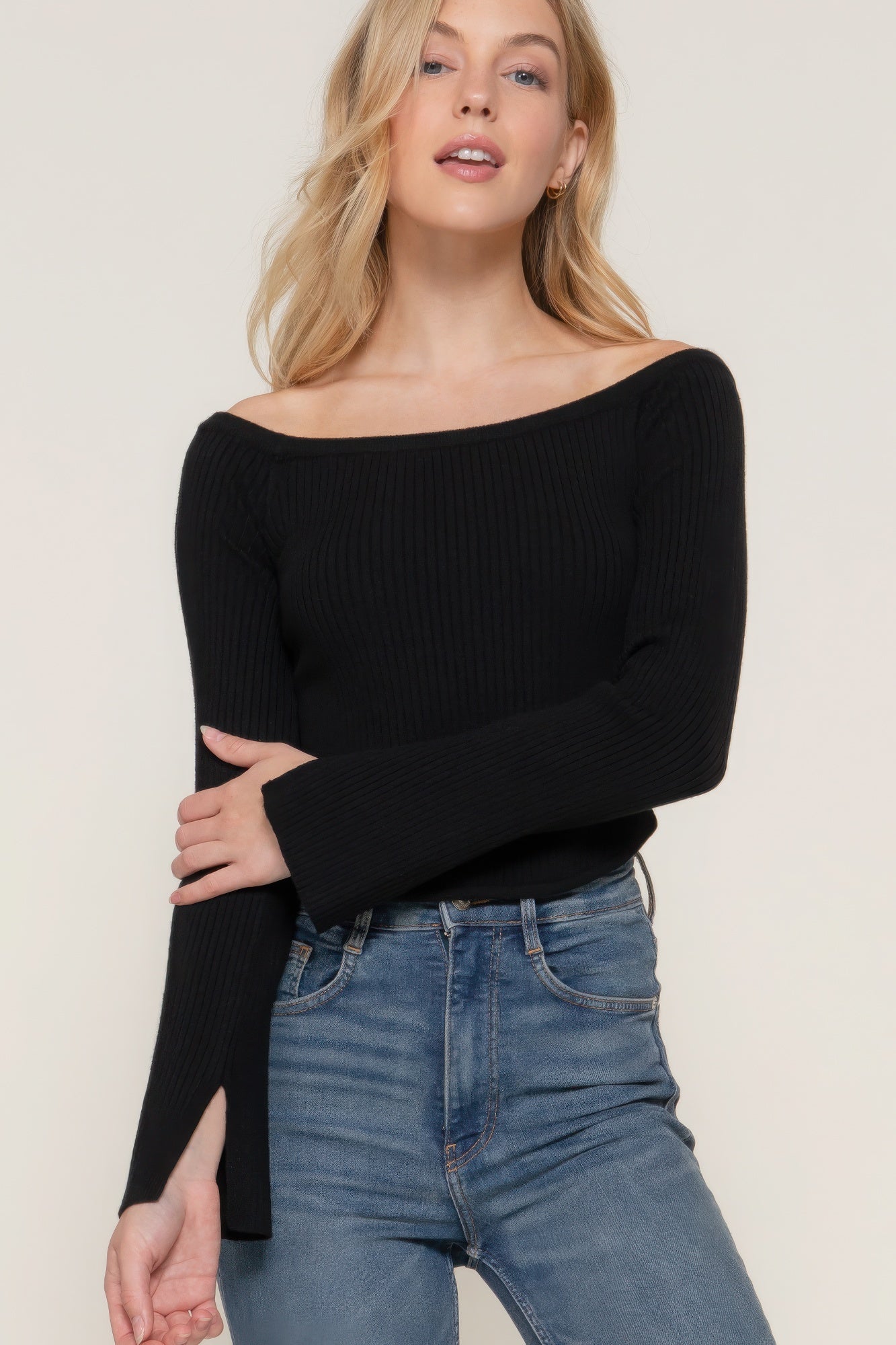 The Blair is our long flare sleeve off-shoulder sweater. This stunning piece is finished with a corset hem for a tailored look. Perfect for evening outings, casual events, or any occasion where you want to showcase an elegant look. Fabric: Made from 49% viscose, 28% polyester, and 23% nylon. Colour: black.