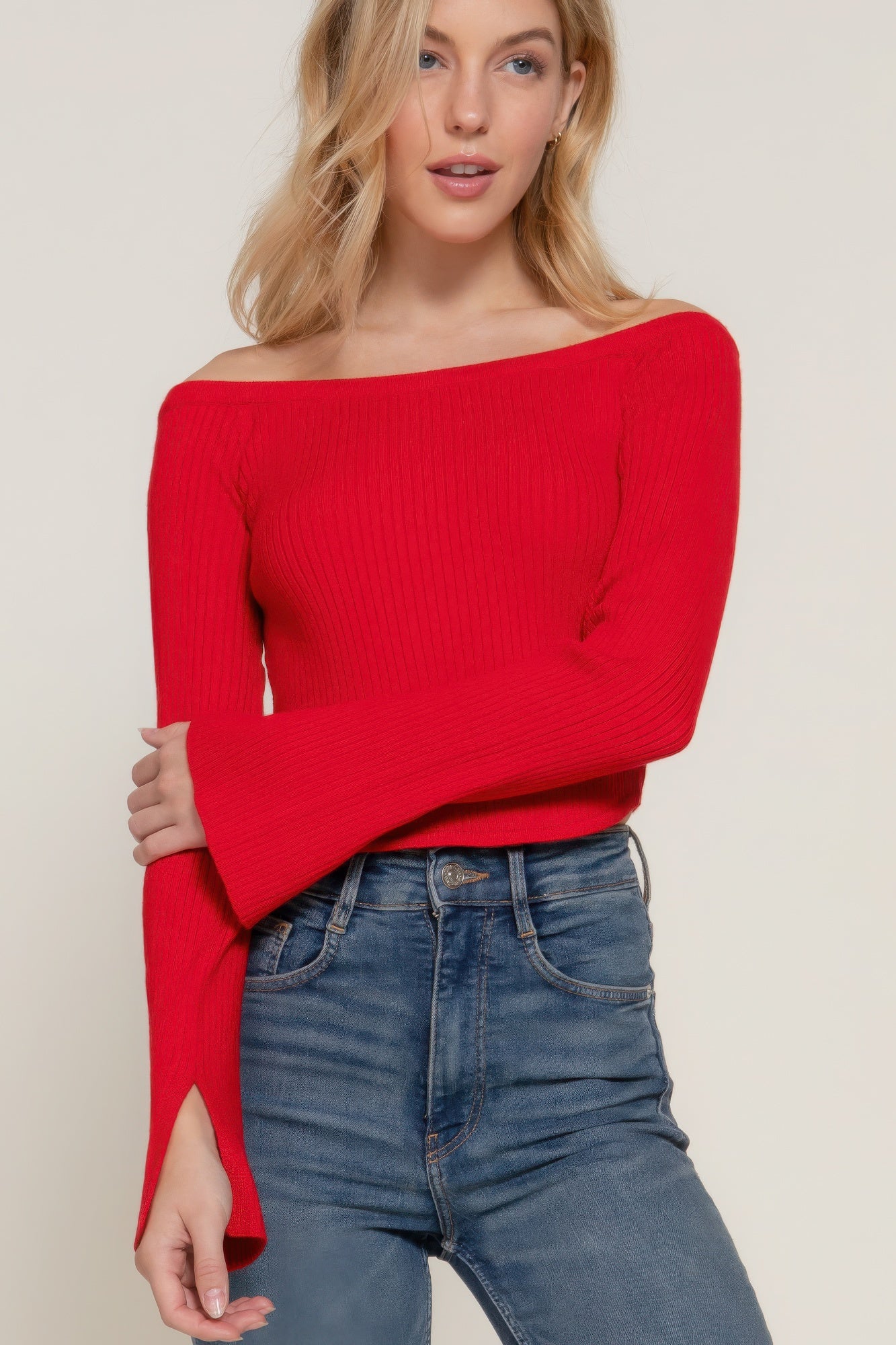 The Blair is our long flare sleeve off-shoulder sweater. This stunning piece is finished with a corset hem for a tailored look. Perfect for evening outings, casual events, or any occasion where you want to showcase an elegant look. Fabric: Made from 49% viscose, 28% polyester, and 23% nylon. Colour: red.