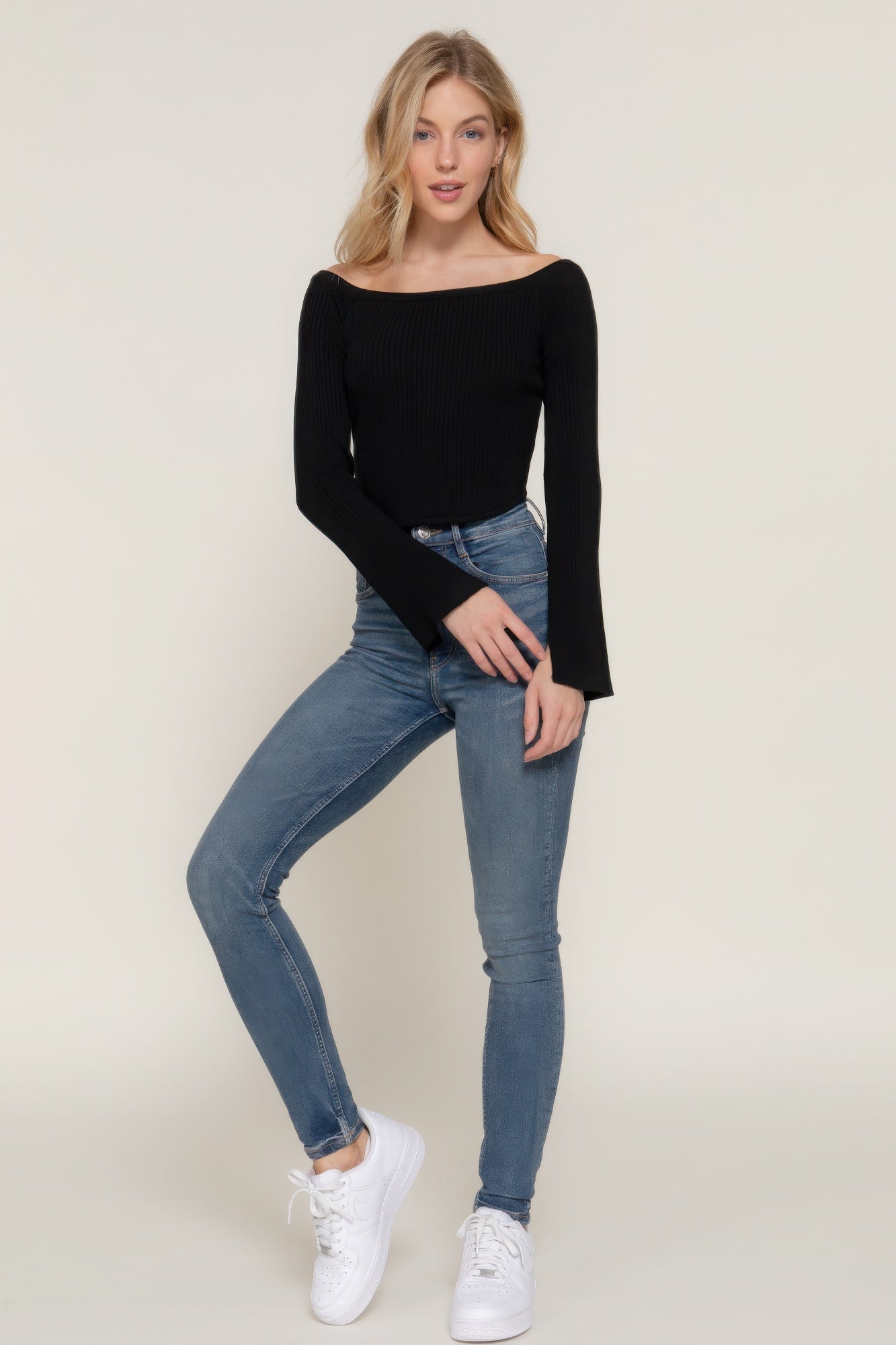 The Blair is our long flare sleeve off-shoulder sweater. This stunning piece is finished with a corset hem for a tailored look. Perfect for evening outings, casual events, or any occasion where you want to showcase an elegant look. Fabric: Made from 49% viscose, 28% polyester, and 23% nylon. Colour: black.