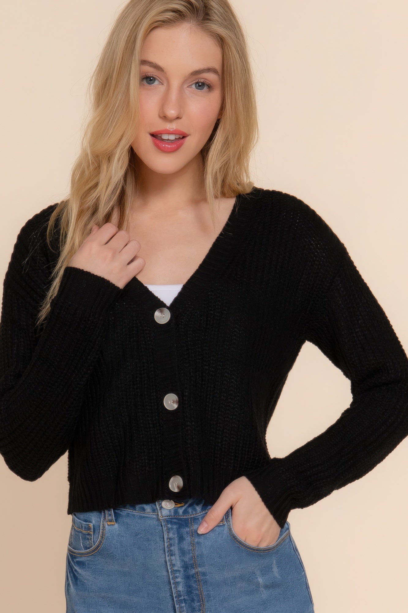 The Kate is our long sleeve v-neck cardigan. It's stylish and versatile piece with a button-down front and a relaxed fit. Ideal for layering over tops and dresses. Perfect for casual outings on cooler days. Fabric: 100% acrylic. Colour: black.