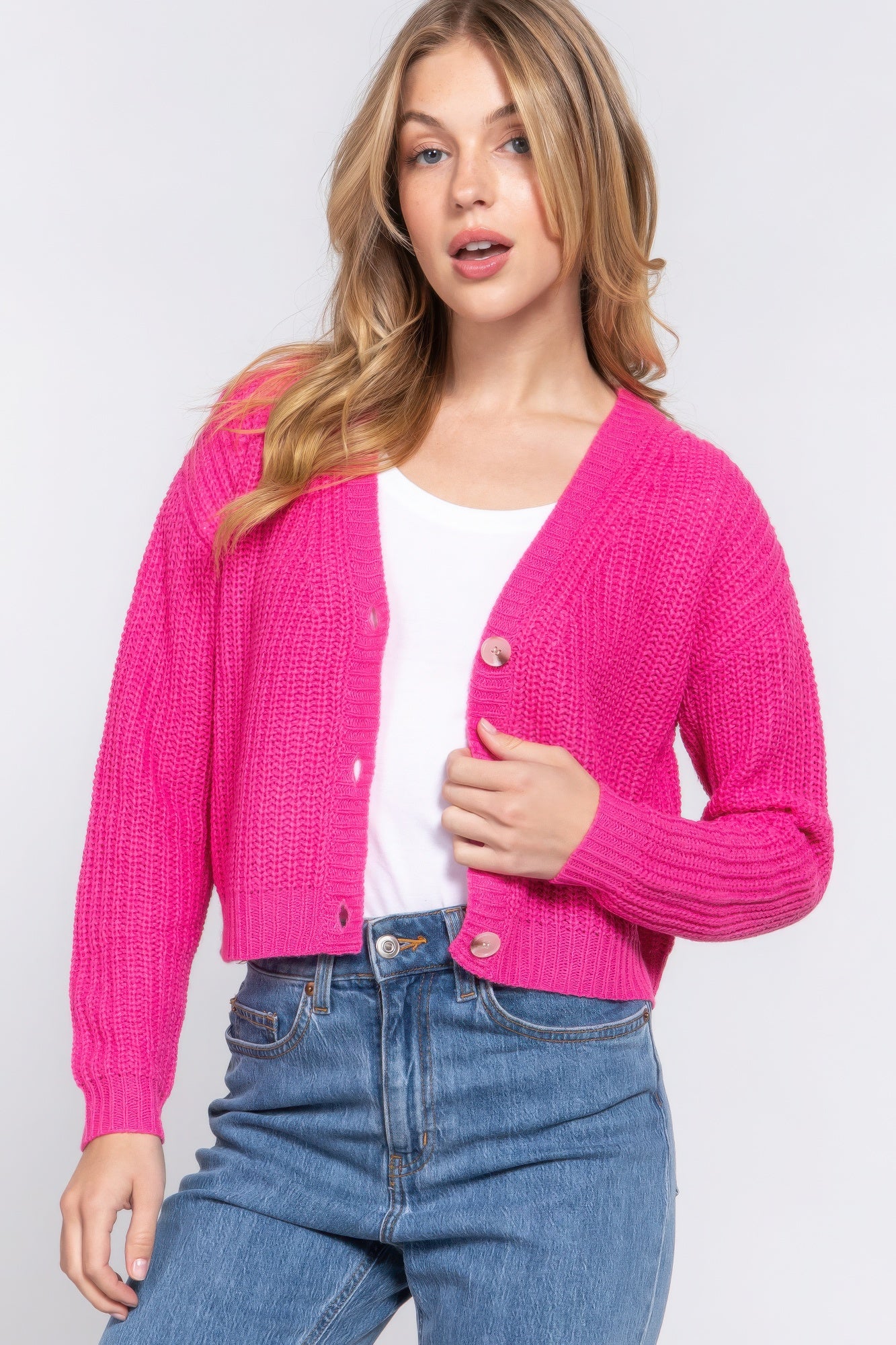 The Kate is our long sleeve v-neck cardigan. It's stylish and versatile piece with a button-down front and a relaxed fit. Ideal for layering over tops and dresses. Perfect for casual outings on cooler days. Fabric: 100% acrylic. Colour: pink.