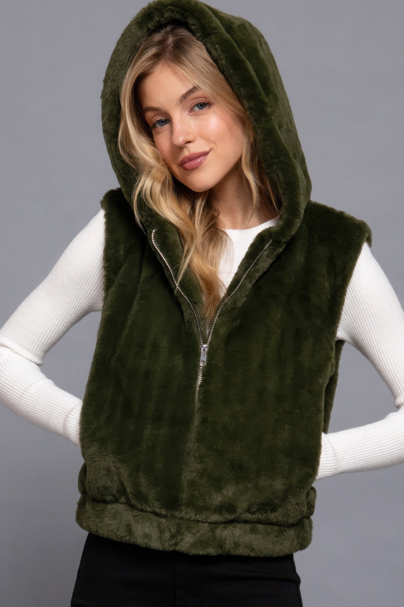 The Rory is our hooded faux fur vest that is perfect for Autumn and Winter. Ideal for layering over your favourite tops or sweaters. Perfect for casual outings on chilly days and as a stylish addition to your everyday wear. Fabric: 100% Polyester; faux fur. Colour: olive green.