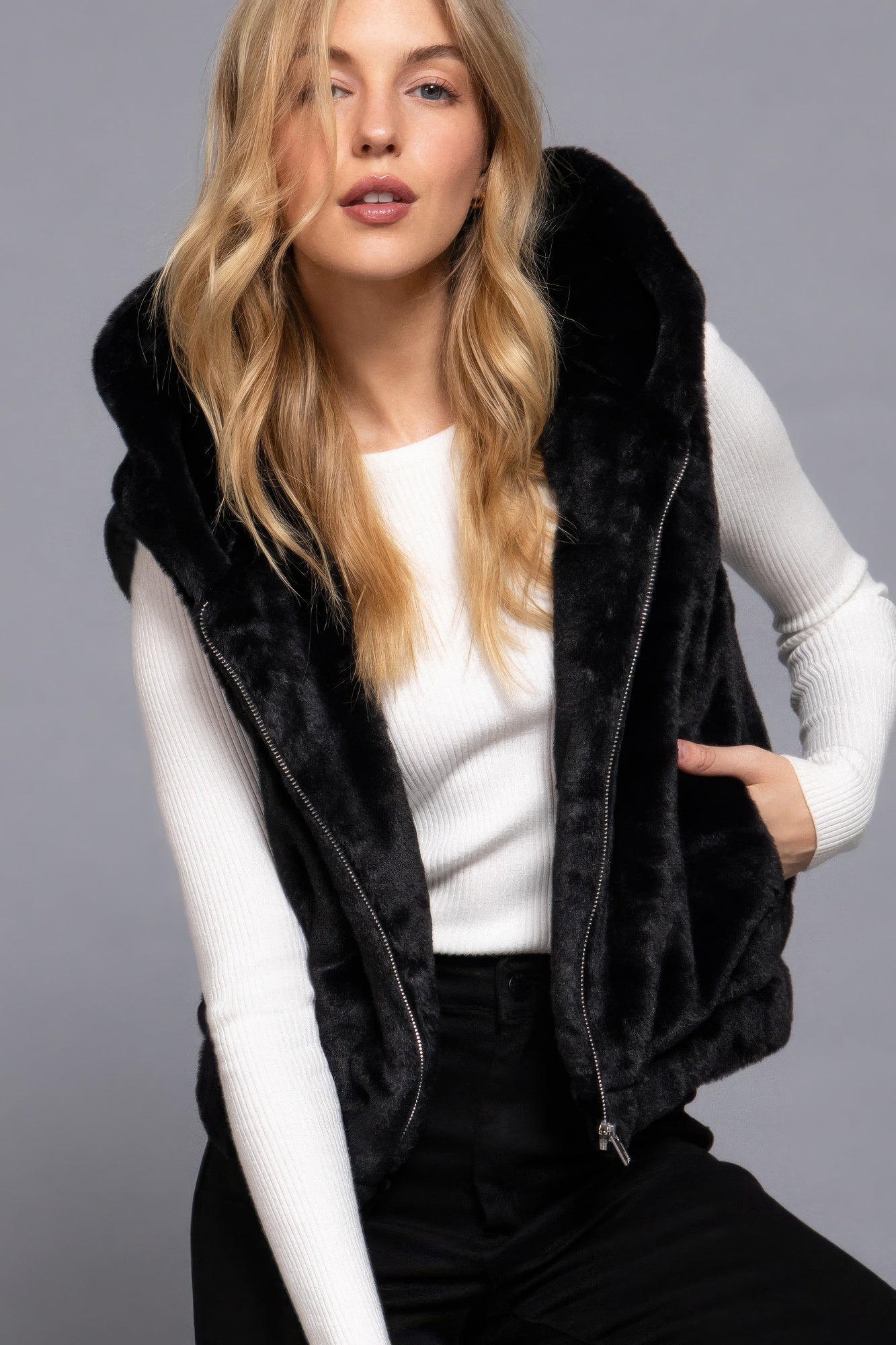 The Rory is our hooded faux fur vest that is perfect for Autumn and Winter. Ideal for layering over your favourite tops or sweaters. Perfect for casual outings on chilly days and as a stylish addition to your everyday wear. Fabric: 100% Polyester; faux fur. Colour: black.